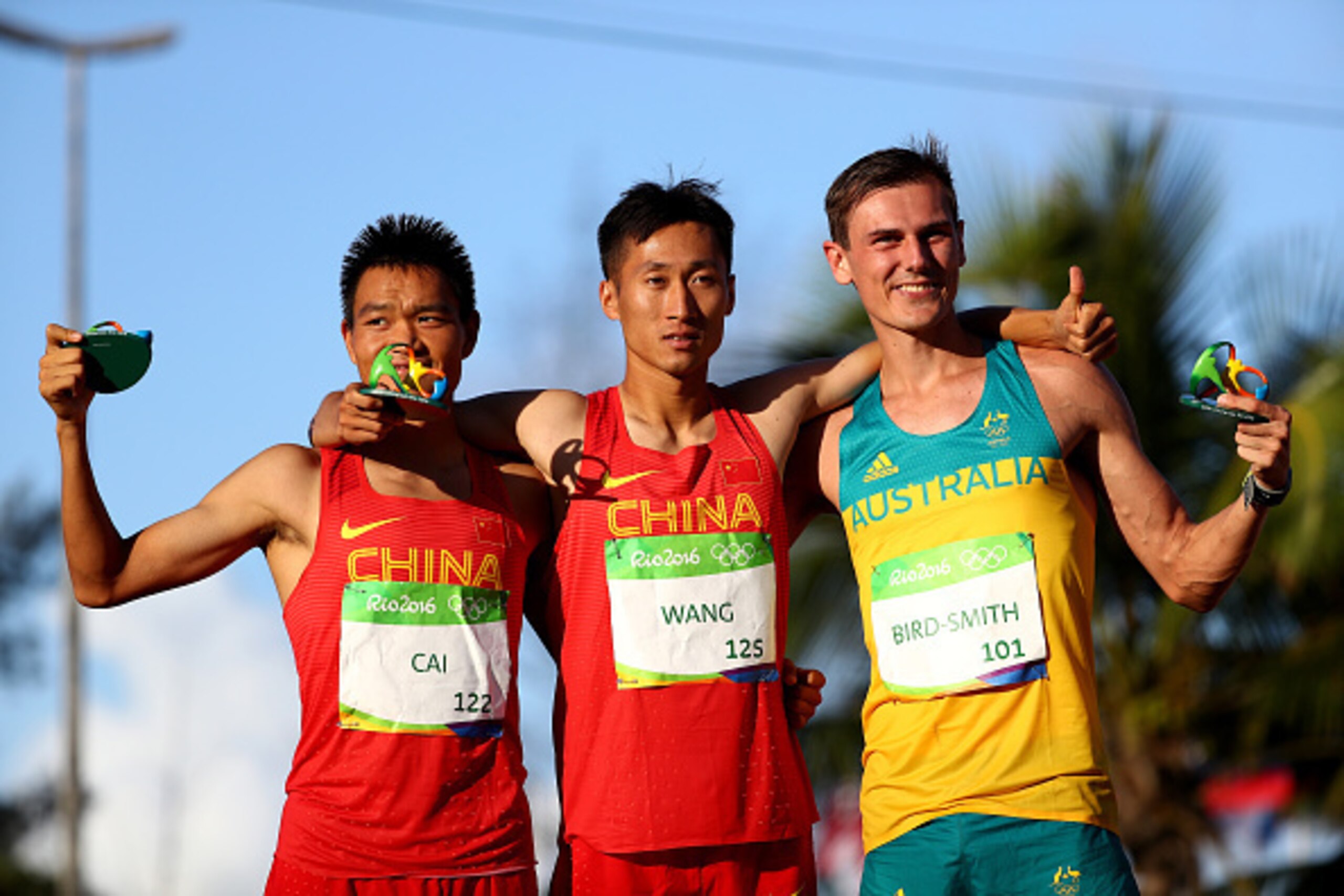 RIO DE JANEIRO, BRAZIL - AUGUST 12:  (L-R) Silver medalist Zelin Cai of China, gold medalist Zhen Wang of China and bronze medalist Dane Bird-Smith of Australia celebrate after the Men's 20km Race Walk on Day 7 of the Rio 2016 Olympic Games at Pontal on A