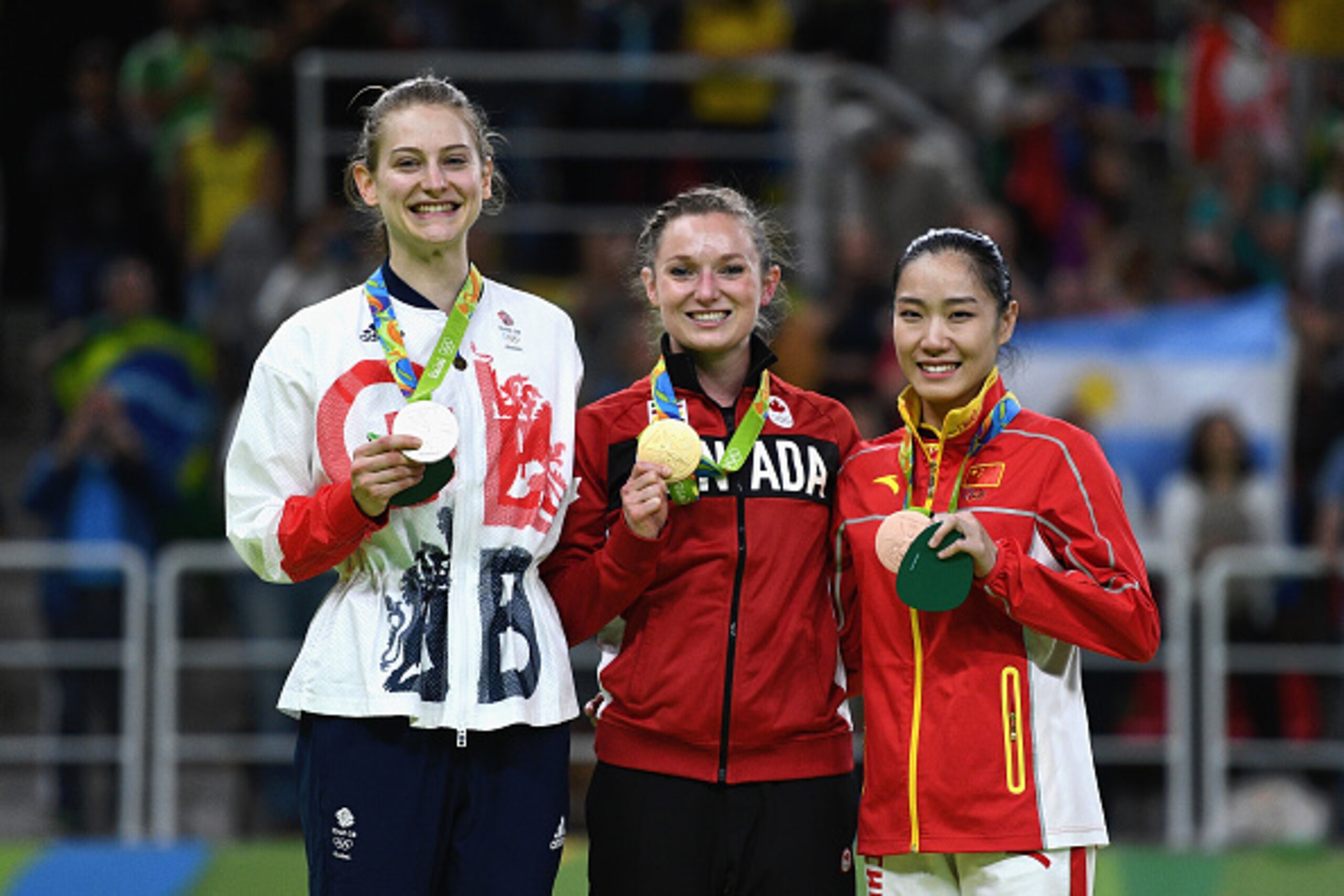 RIO DE JANEIRO, BRAZIL - AUGUST 12:  (L-R) Silver medalist Bryony Page of Great Britain, gold medalist Rosannagh Maclennan of Canada and bronze medalist Dan Li of China pose during the medal ceremony for the Trampoline Gymnastics Women's Final on Day 7 of