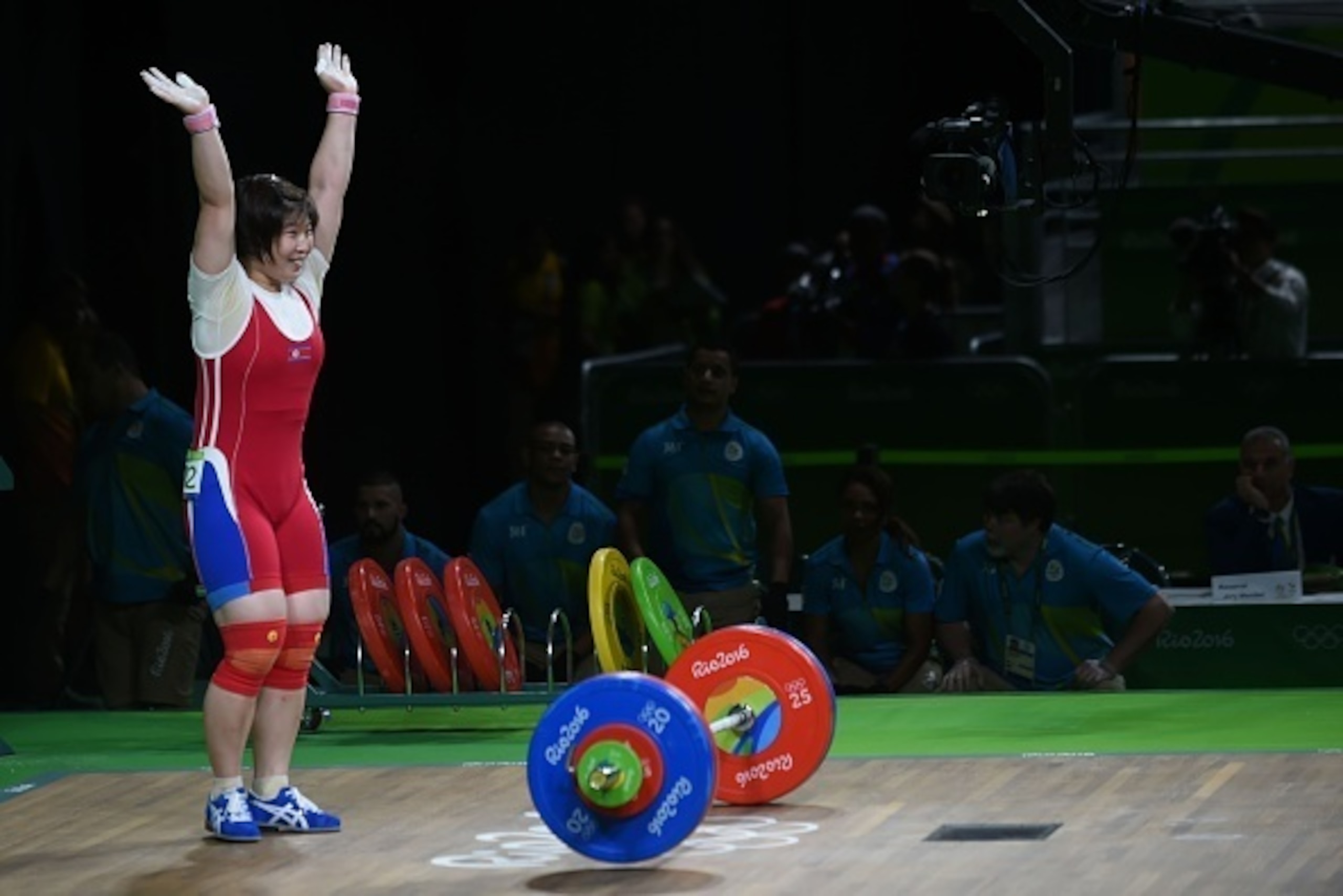 North Korea's Rim Jong Sim celebrates after winning the gold medal during the women's weightlifting 75kg event during the Rio 2016 Olympics Games in Rio de Janeiro on August 12, 2016.  / AFP / GOH Chai Hin        (Photo credit should read GOH CHAI HIN/AFP