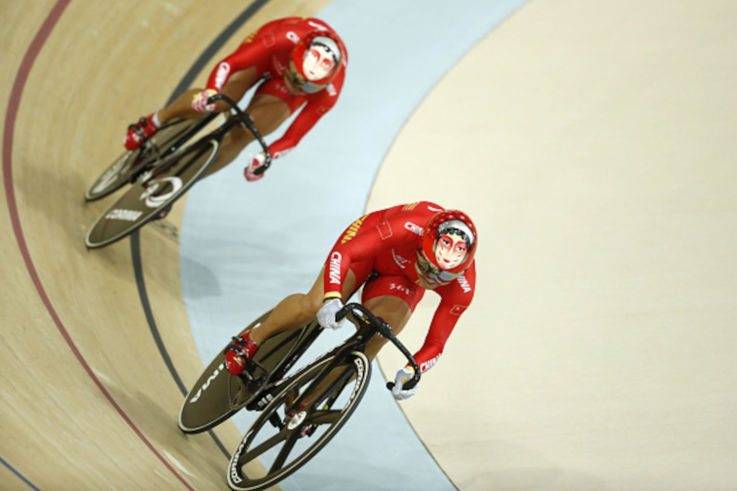 China's Zhong Tianshi (L) and China's Gong Jinjie compete in the women's Team Sprint finals track cycling event at the Velodrome during the Rio 2016 Olympic Games in Rio de Janeiro on August 12, 2016. / AFP / Odd Andersen        (Photo credit should read 