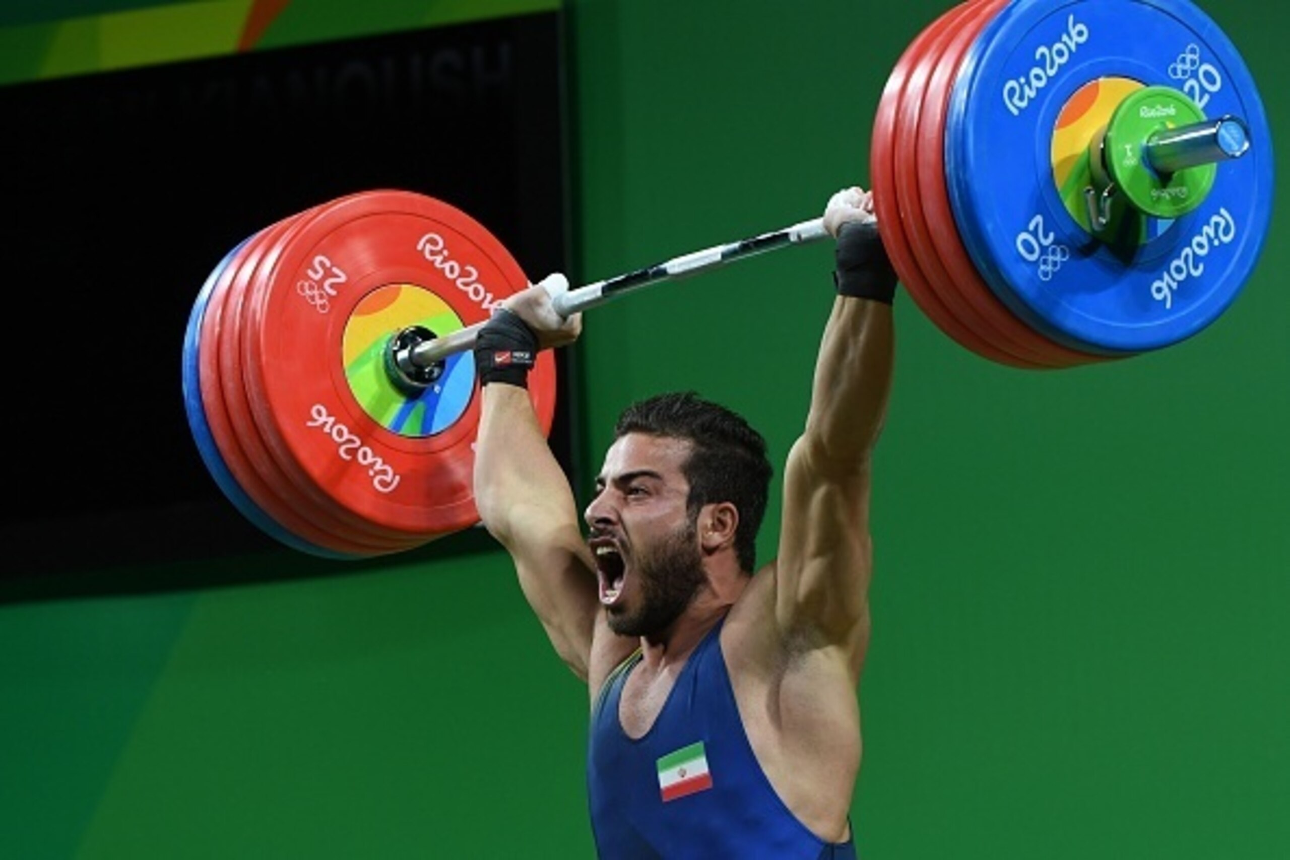 Iran's Kianoush Rostami competes during the men's weightlifting 85kg event during the Rio 2016 Olympics Games in Rio de Janeiro on August 12, 2016. / AFP / GOH Chai Hin        (Photo credit should read GOH CHAI HIN/AFP/Getty Images)