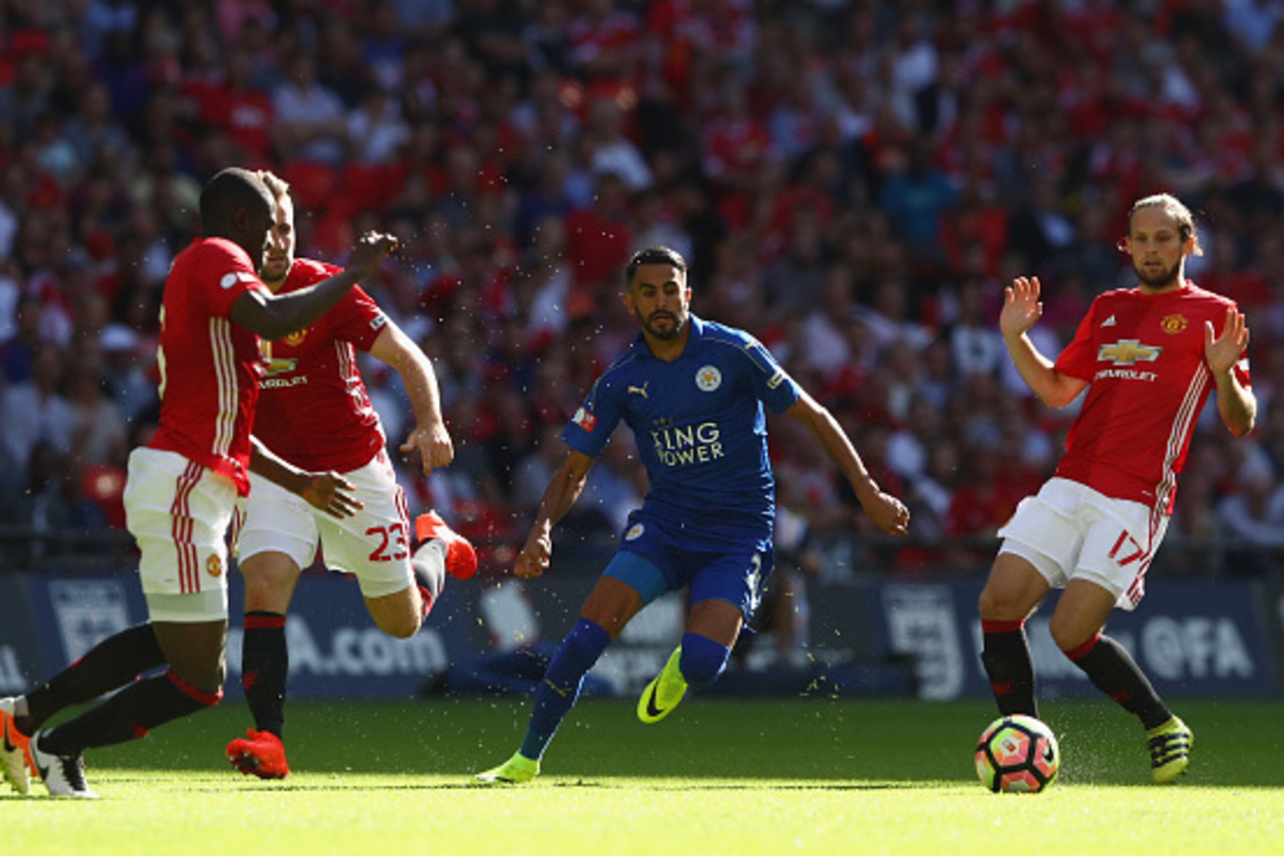 LONDON, ENGLAND - AUGUST 07:  Riyad Mahrez of Leicester City cuts between Eric Bailly (L), Luke Shaw (2L) and Daley Blind (R) of Manchester United during the Community Shield match between Leicester City and Manchester United at Wembley Stadium on August 