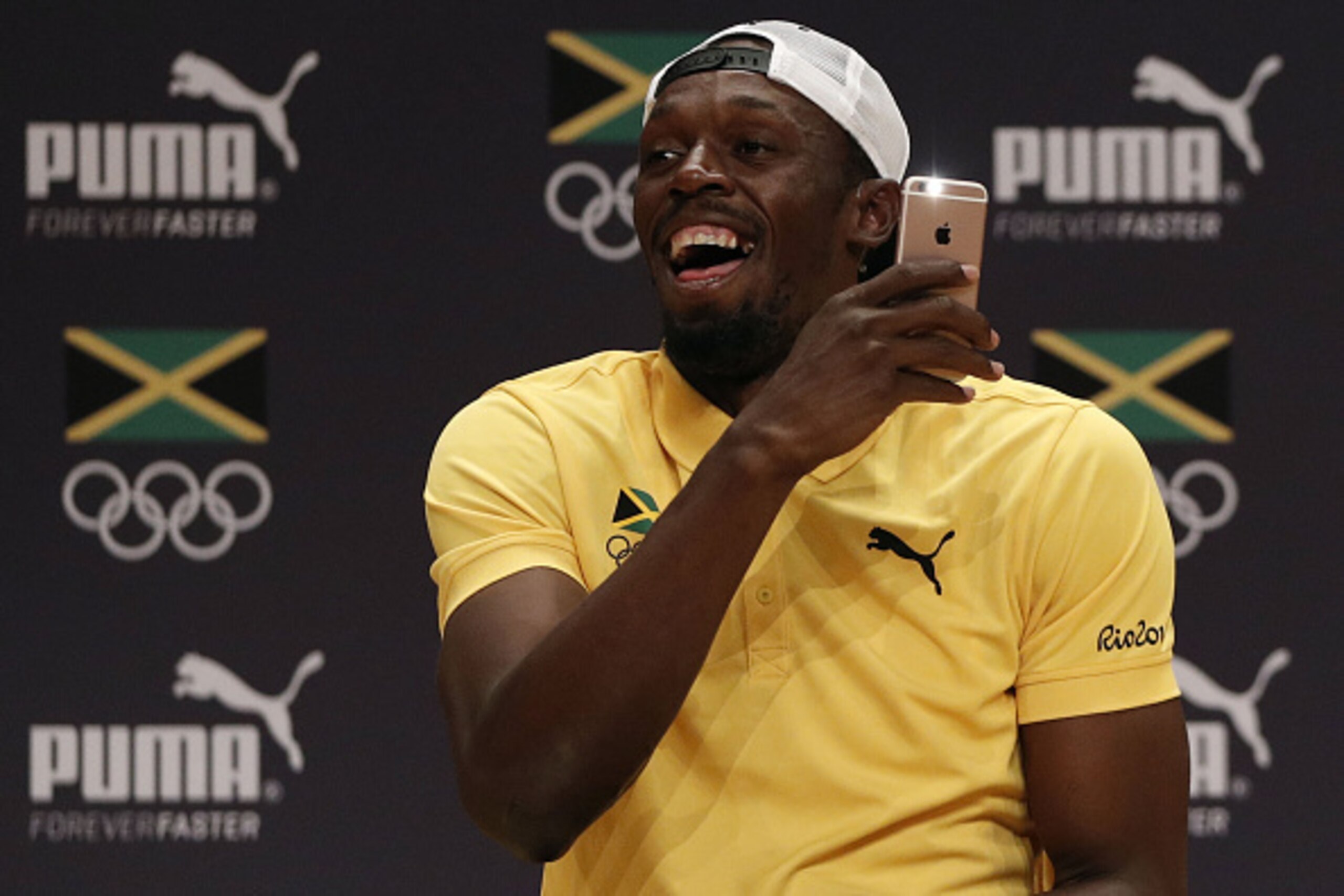 Usain Bolt takes a video of the audience during a Jamaican Olympic Association and Puma press conference at the Cidade Das Artes in Rio de Janeiro on August 8, 2016.  / AFP / Adrian DENNIS        (Photo credit should read ADRIAN DENNIS/AFP/Getty Images)