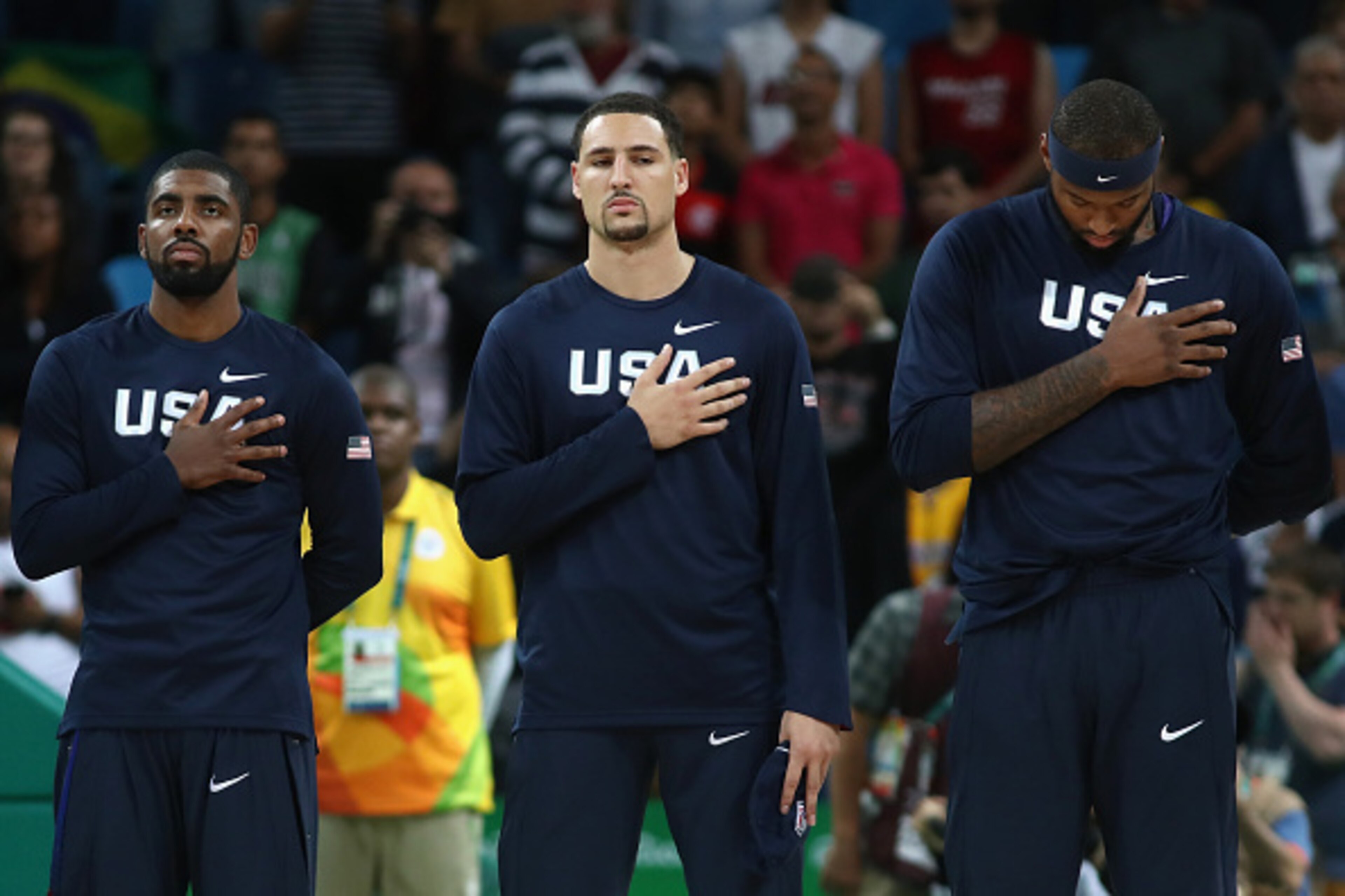 RIO DE JANEIRO, BRAZIL - AUGUST 10: Kyrie Irving #10, Klay Thompson #11 and Demarcus Cousins #12 of United States stand for the national anthem prior to the Preliminary Round Basketball game between Australia and the United States on Day 5 of the Rio 2016