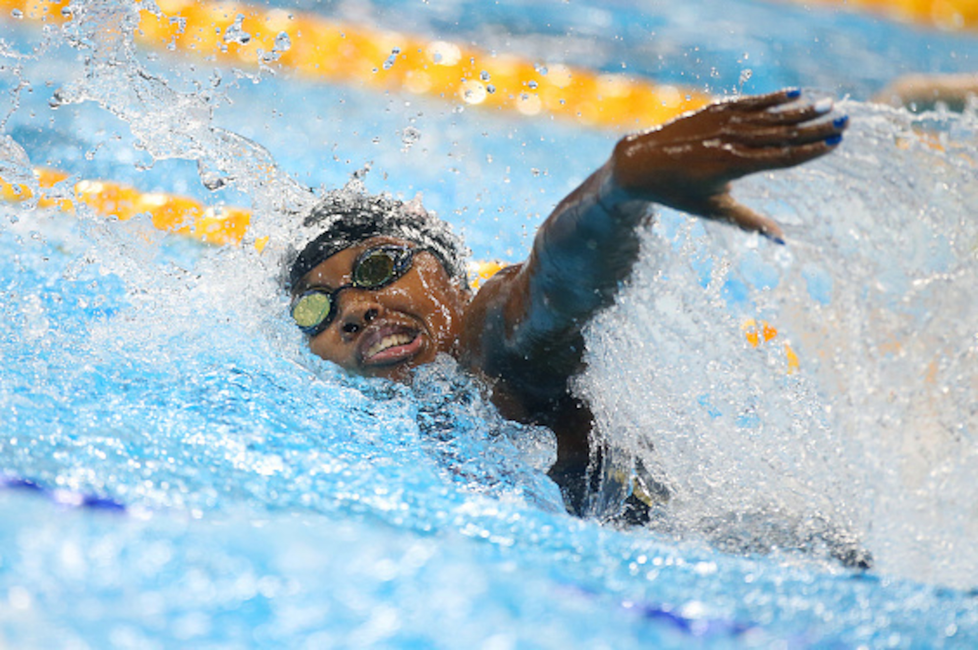 RIO DE JANEIRO, BRAZIL - AUGUST 11: Simone Manuel of USA competes in the Women's 100m Freestyle Final on day 6 of the Rio 2016 Olympic Games at Olympic Aquatics Stadium on August 11, 2016 in Rio de Janeiro, Brazil. (Photo by Jean Catuffe/Getty Images) RIO DE JANEIRO, BRAZIL - AUGUST 11: Simone Manuel of USA competes in the Women's 100m Freestyle Final on day 6 of the Rio 2016 Olympic Games at Olympic Aquatics Stadium on August 11, 2016 in Rio de Janeiro, Brazil. (Photo by Jean Catuffe/Getty Images)