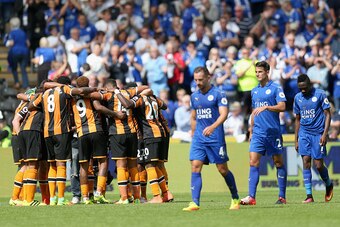 HULL, ENGLAND - AUGUST 13: Hull City players create a huddle after the final whistle while the Leicester City players show dejection during the Premier League match between Hull City and Leicester City at KCOM Stadium on August 13, 2016 in Hull, England. 