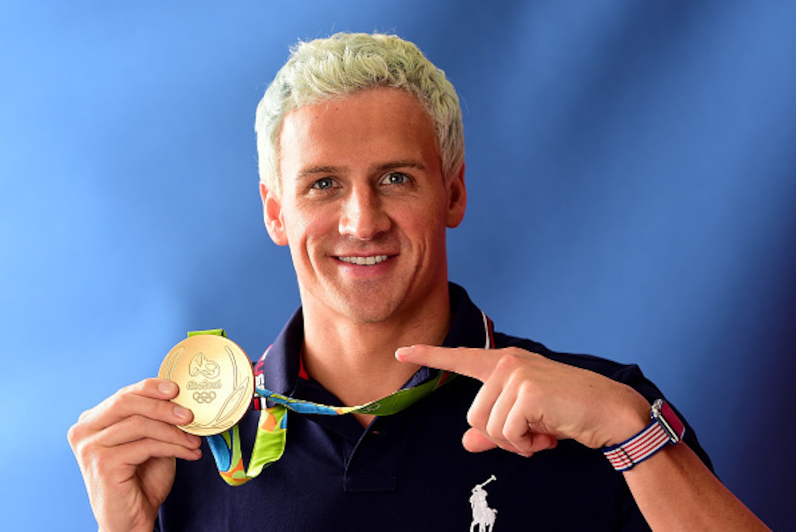 RIO DE JANEIRO, BRAZIL - AUGUST 12:  (BROADCAST - OUT) Swimmer, Ryan Lochte of the United States poses for a photo with his gold medal on the Today show set on Copacabana Beach on August 12, 2016 in Rio de Janeiro, Brazil.  (Photo by Harry How/Getty Image