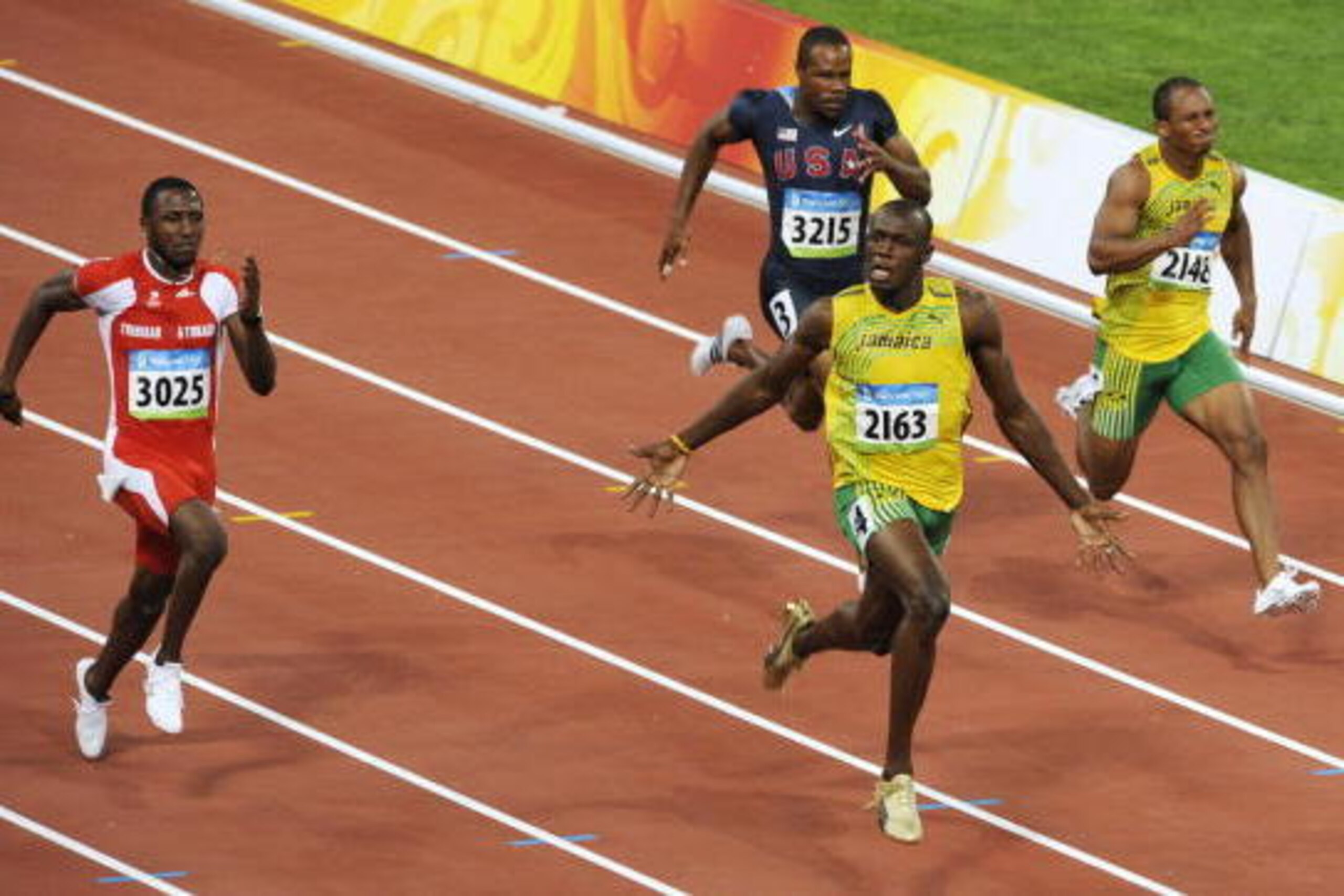Jamaica's Usain Bolt (front) celebrates after winning the men's 100m final at the 'Bird's Nest' National Stadium during the 2008 Beijing Olympic Games on August 16, 2008. Bolt won the Olympic Games men's 100m gold medal in a new world record time of 9.69s