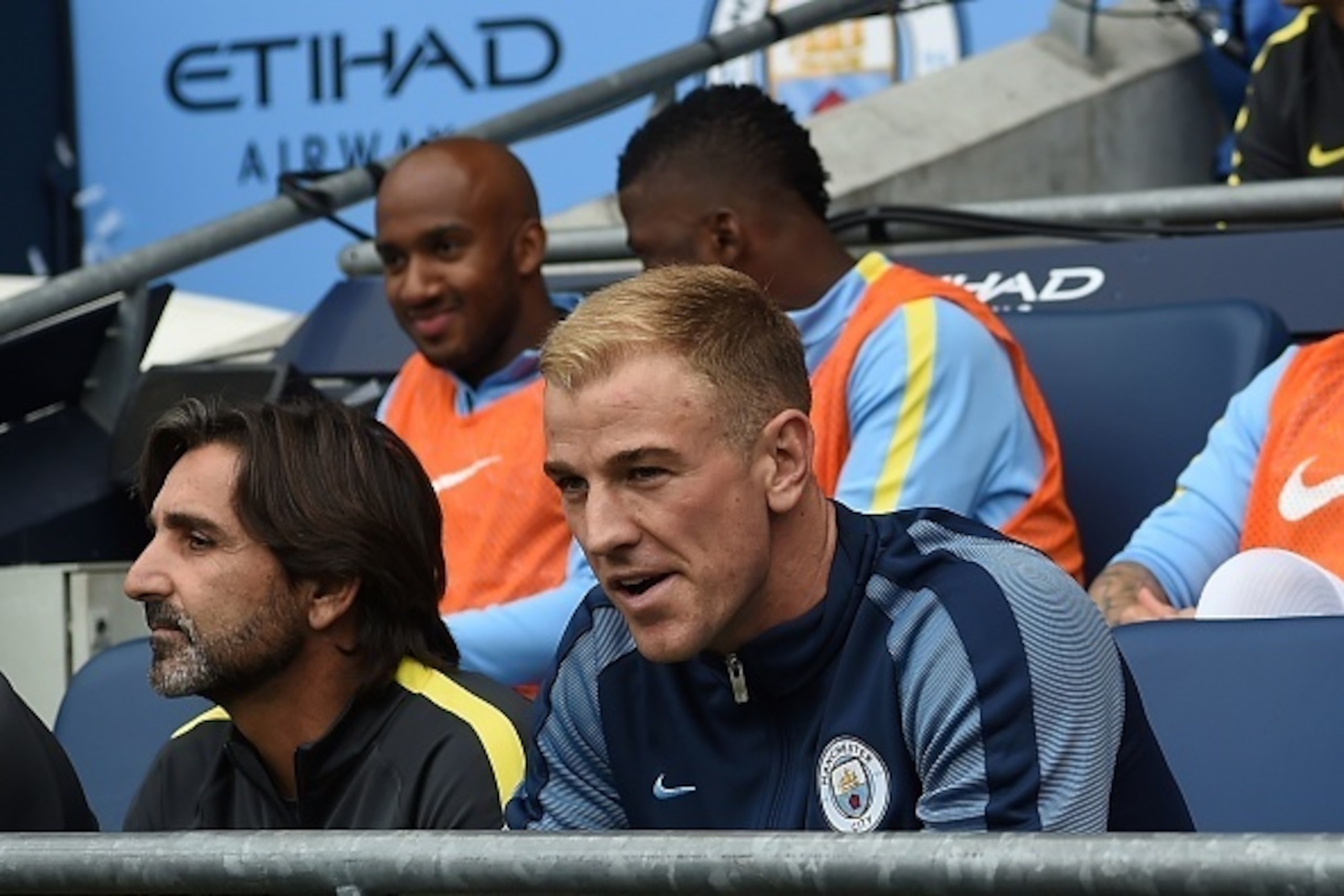 Manchester City's English goalkeeper Joe Hart (R) sits on the substitutes bench for the English Premier League football match between Manchester City and Sunderland at the Etihad Stadium in Manchester, north west England, on August 13, 2016.
Manchester Ci