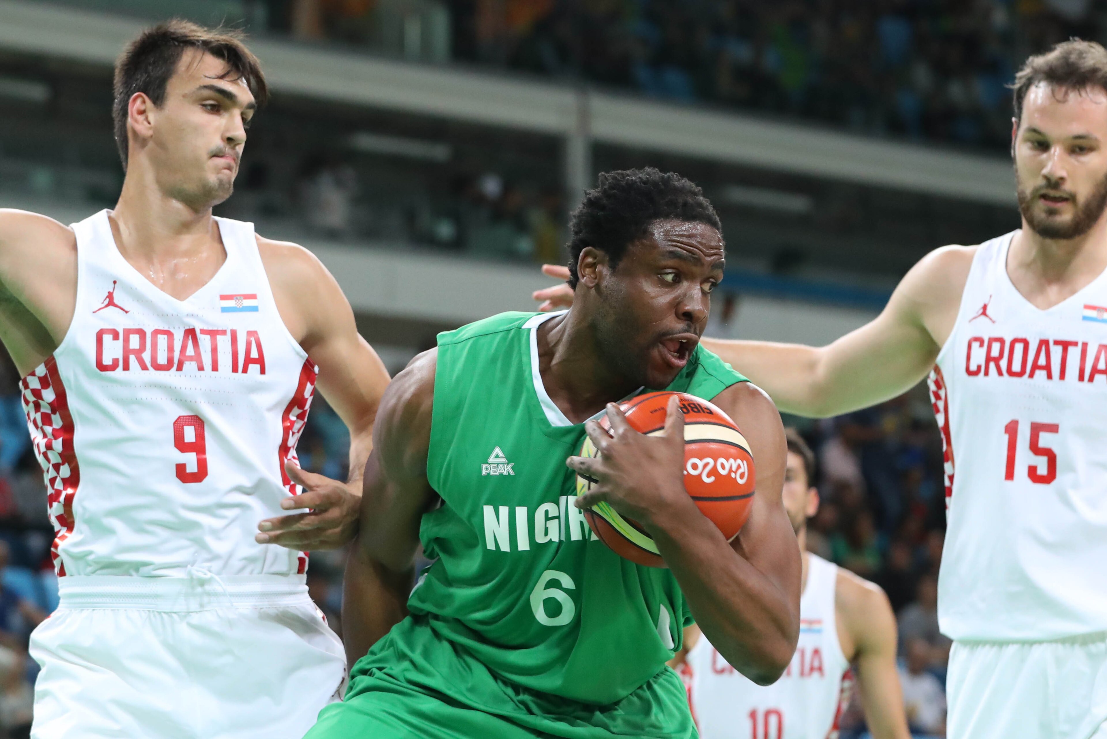 Aug 13, 2016; Rio de Janeiro, Brazil; Nigeria center Ike Diogu (6) brings down a rebound while guarded by Croatia forward Dario Saric (9) and center Miro Bilan (15) during the men's preliminary game in the Rio 2016 Summer Olympic Games at Carioca Arena 1. Aug 13, 2016; Rio de Janeiro, Brazil; Nigeria center Ike Diogu (6) brings down a rebound while guarded by Croatia forward Dario Saric (9) and center Miro Bilan (15) during the men's preliminary game in the Rio 2016 Summer Olympic Games at Carioca Arena 1.