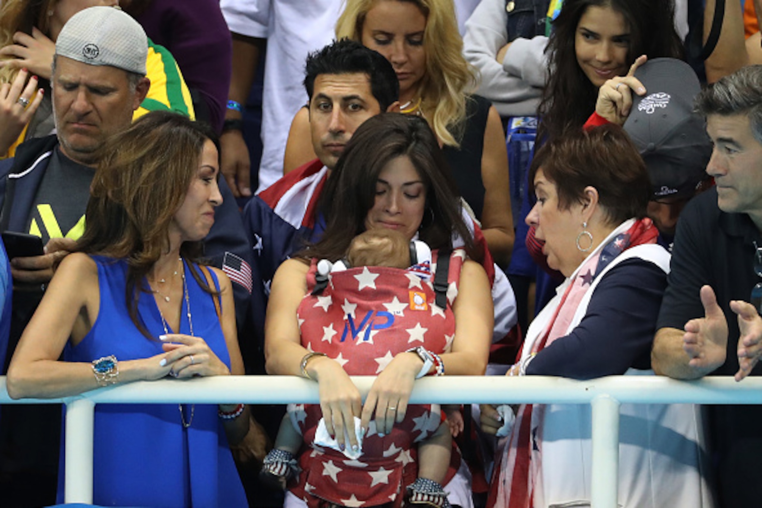 RIO DE JANEIRO, BRAZIL - AUGUST 13:  Nicole Johnson, fiancee of Michael Phelps of the Unites States, holds their son Boomer and Debbie Phelps, Michael's mother, attends Day 8 of the Rio 2016 Olympic Games at the Olympic Aquatics Stadium on August 13, 2016