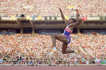 BARCELONA, SPAIN:  Carl Lewis of the USA flies through the air during the finals of the Men's Olympic long jump competition, Barcelona, 06 August 1992. Lewis won the gold medal with a jump of 8.67 meters. Lewis broke 13 world records in his career, won 9 