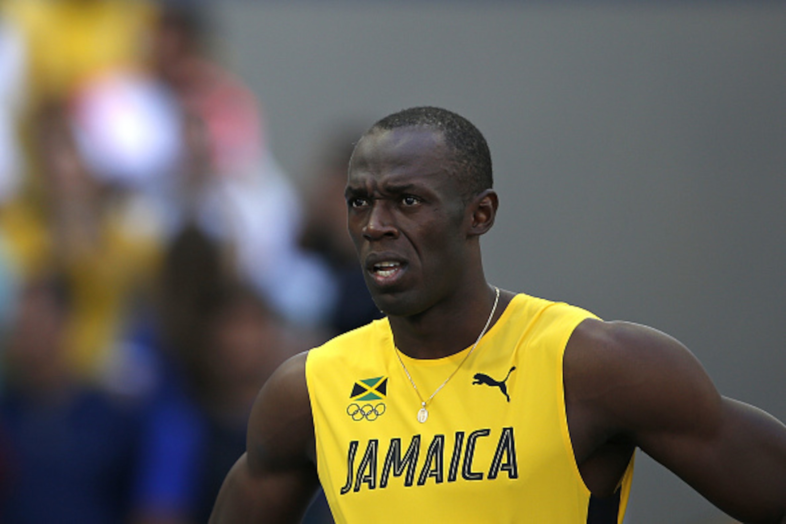 Jamaica's Usain Bolt looks on in the Men's 100m Round 1 during the athletics event at the Rio 2016 Olympic Games at the Olympic Stadium in Rio de Janeiro on August 13, 2016.   / AFP / Adrian DENNIS        (Photo credit should read ADRIAN DENNIS/AFP/Getty 