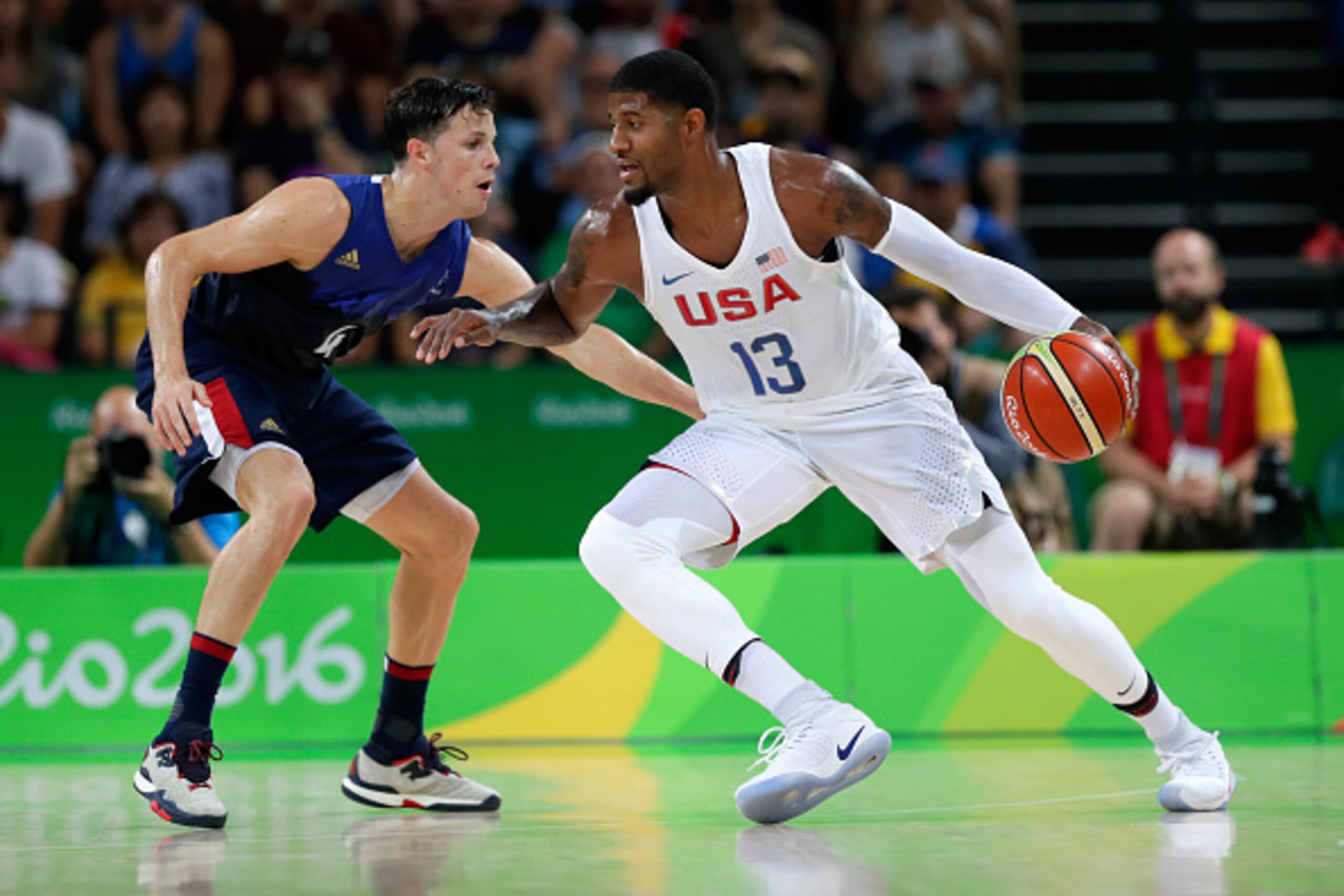 RIO DE JANEIRO, BRAZIL - AUGUST 14:  Paul George #13 of United States moves the ball against Thomas Heurtel #4 of France during a Men's Preliminary Round Group A game between the United States and France on Day 9 of the Rio 2016 Olympic Games at Carioca A