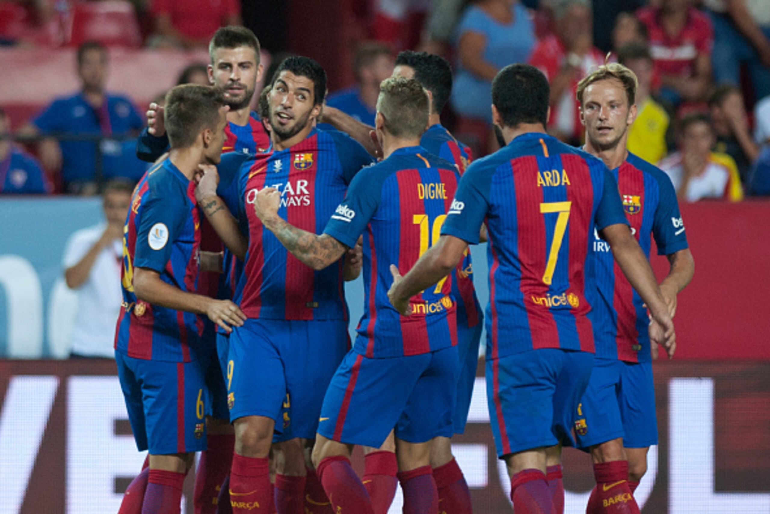 Barcelona's Uruguayan forward Luis alberto Suarez (2nd L) celebrates with his teammates after scoring during the first leg of the Spanish Supercup football match between Sevilla FC and FC Barcelona at the Ramon Sanchez Pizjuan stadium in Sevilla on August