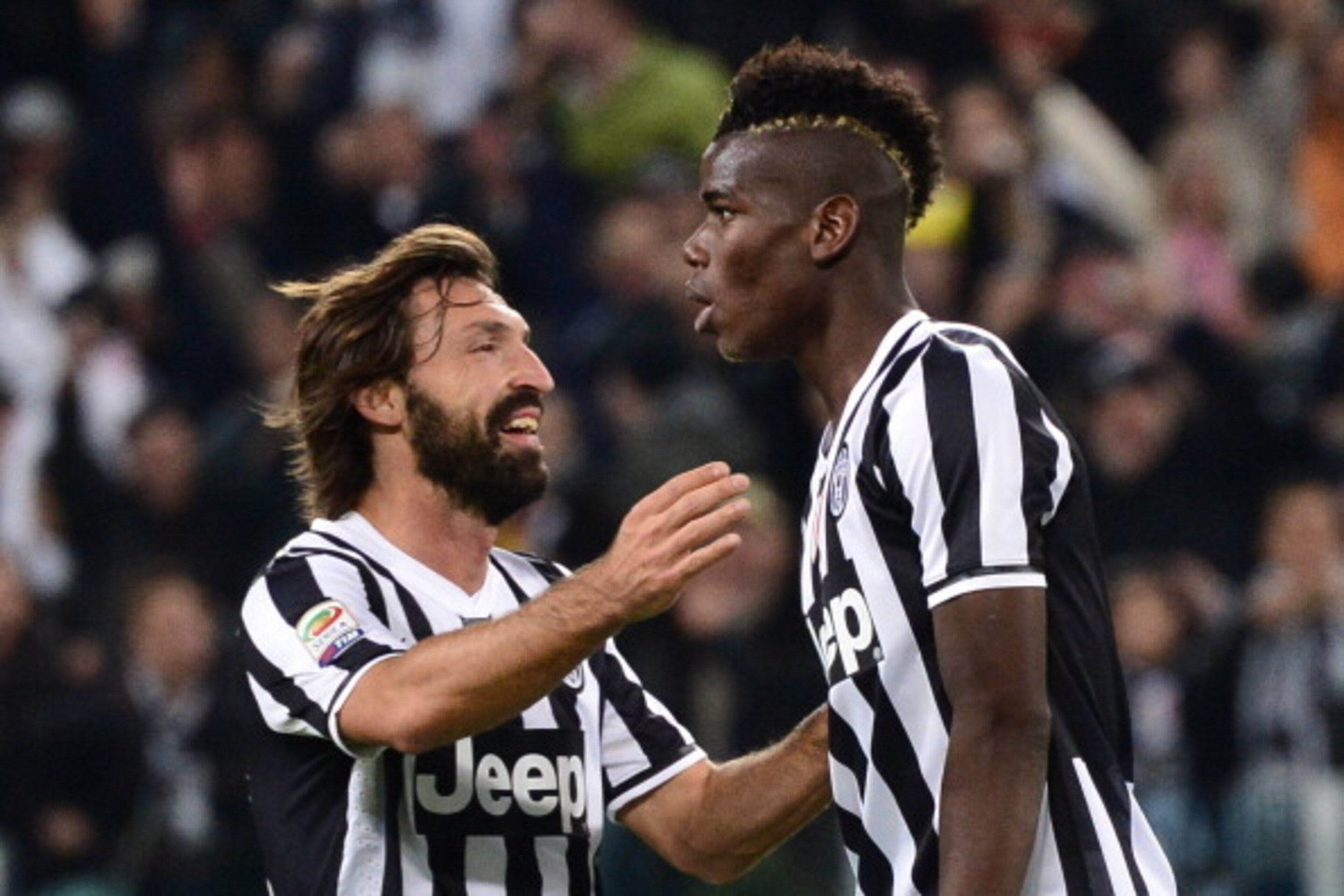 Juventus' French midfielder Paul Labile Pogba (R) celebrates after scoring a goal, with Juventus' midfielder Andrea Pirlo, during the Italian Serie A match between Juventus and Napoli at the Juventus stadium in Turin on November 10, 2013. AFP PHOTO / GIUS