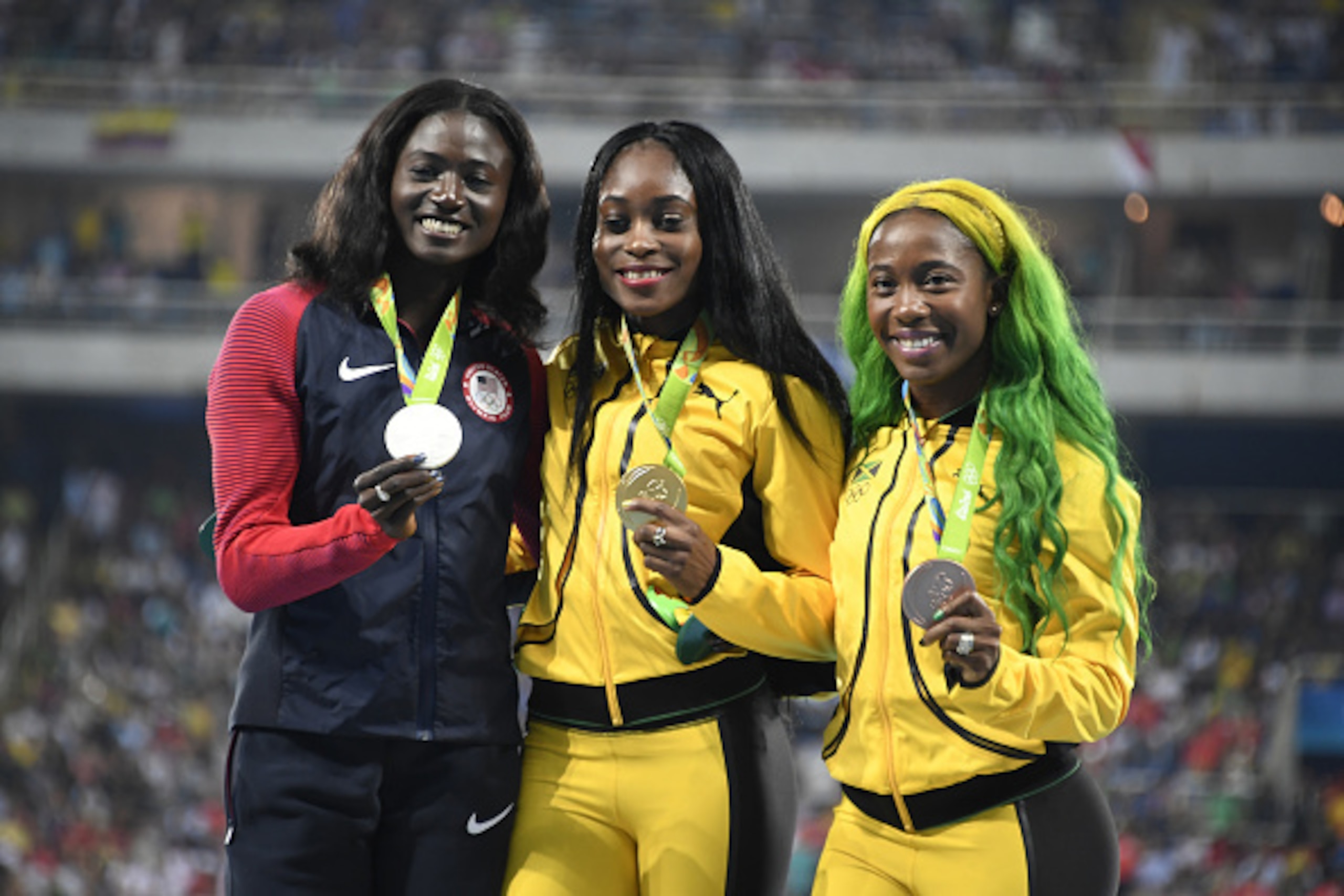 (L-R) Silver medallist USA's Tori Bowie, gold medallist Jamaica's Elaine Thompson, and bronze medallist Jamaica's Shelly-Ann Fraser-Pryce pose on the podium for women's 100m Final at the athletics during the Rio 2016 Olympic Games at the Olympic Stadium i