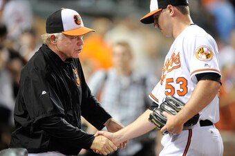 BALTIMORE, MD - JUNE 06:  Manager Buck Showalter #26 of the Baltimore Orioles celebrates with Zach Britton #53 after a 4-1 victory against the Kansas City Royals at Oriole Park at Camden Yards on June 6, 2016 in Baltimore, Maryland.  (Photo by G Fiume/Get
