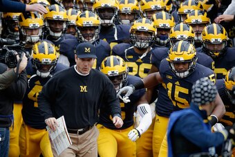 ANN ARBOR, MI - NOVEMBER 28: Head coach Jim Harbaugh of the Michigan Wolverines leads his team on the field before the start of their game against the Ohio State Buckeyes at Michigan Stadium on November 28, 2015 in Ann Arbor, Michigan.  (Photo by Gregory 