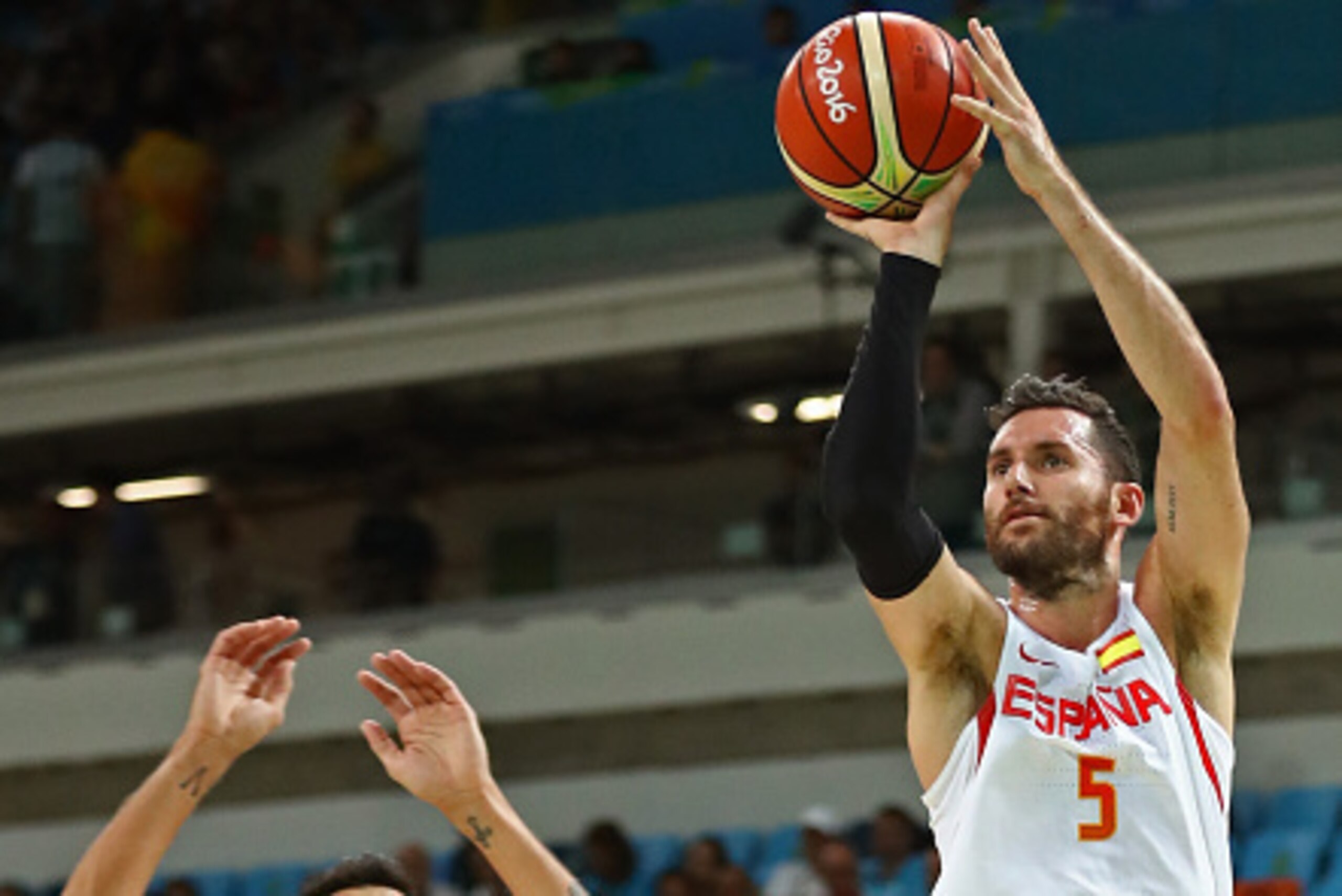 RIO DE JANEIRO, BRAZIL - AUGUST 15:  Rudy Fernandez #5 of Spain shoots over Carlos Delfino #10 of Argentina during a Men's Basketball Preliminary Round Group B game between Spain and Argentina on Day 10 of the Rio 2016 Olympic Games at Carioca Arena 1 on 