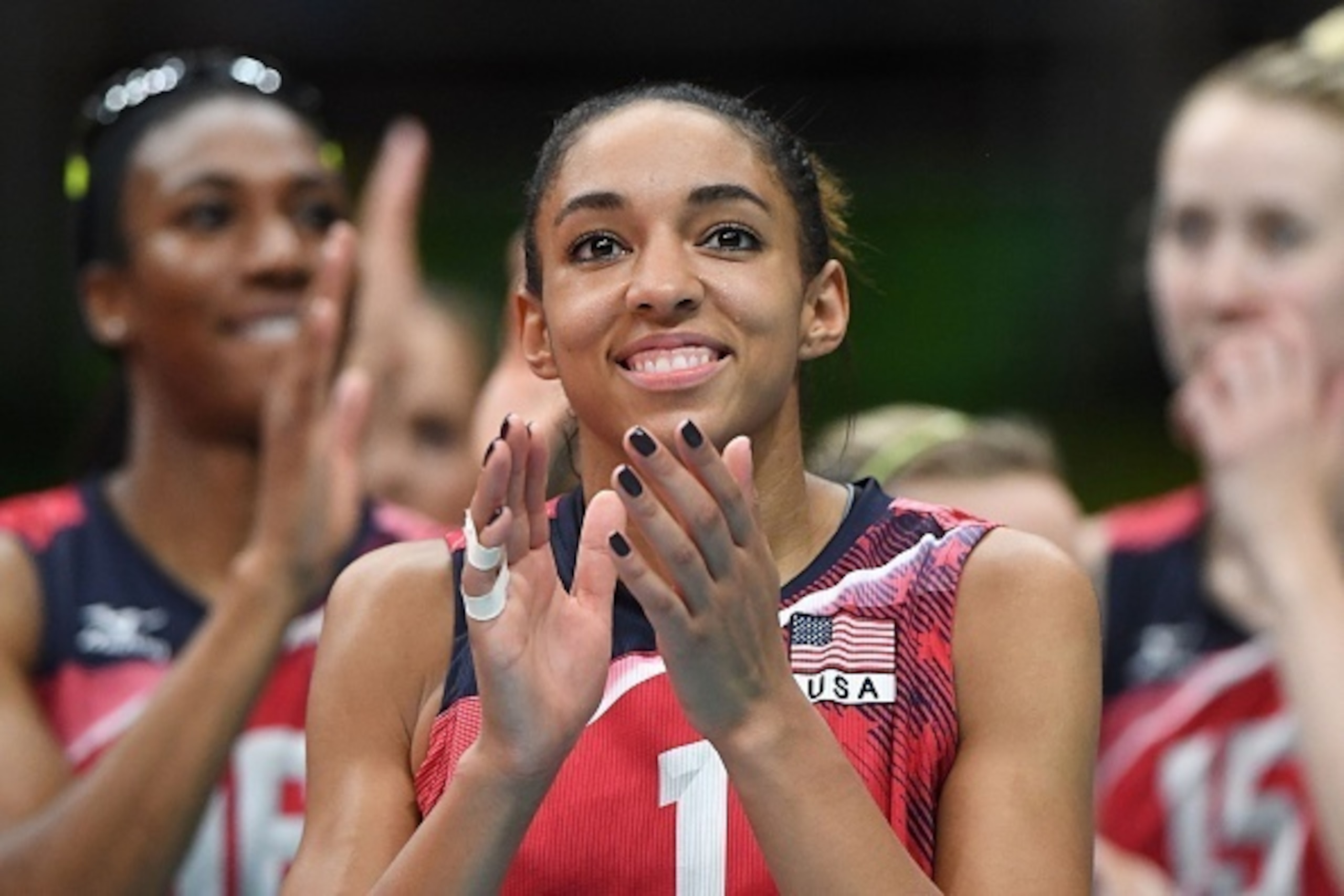 US Alisha Glass (C) reacts after their team won the women's qualifying volleyball match between the USA and Serbia at the Maracanazinho stadium in Rio de Janeiro on August 10, 2016, during the Rio 2016 Olympic Games.
The US won the match. / AFP / PEDRO UG