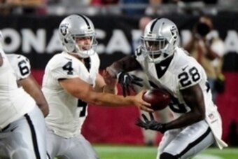 Aug 12, 2016; Glendale, AZ, USA; Oakland Raiders quarterback Derek Carr (4) hands off to running back Latavius Murray (28) during the first half against the Arizona Cardinals at University of Phoenix Stadium. Mandatory Credit: Matt Kartozian-USA TODAY Spo