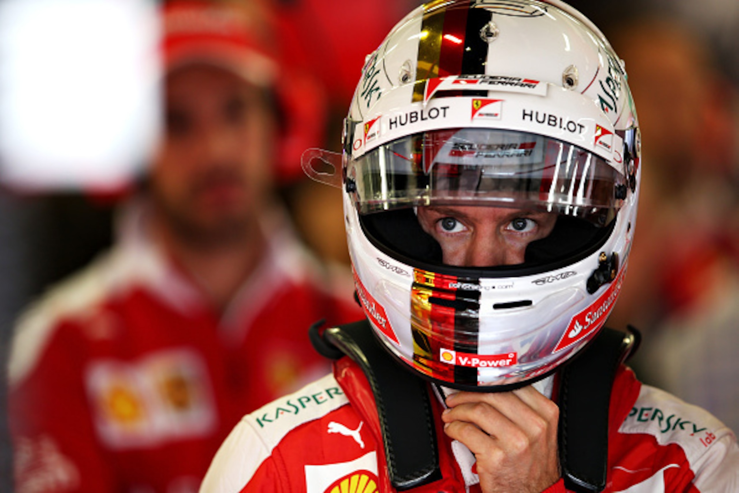 NORTHAMPTON, ENGLAND - JULY 08:  Sebastian Vettel of Germany and Ferrari wears his helmet in the garage during practice for the Formula One Grand Prix of Great Britain at Silverstone on July 8, 2016 in Northampton, England.  (Photo by Charles Coates/Getty