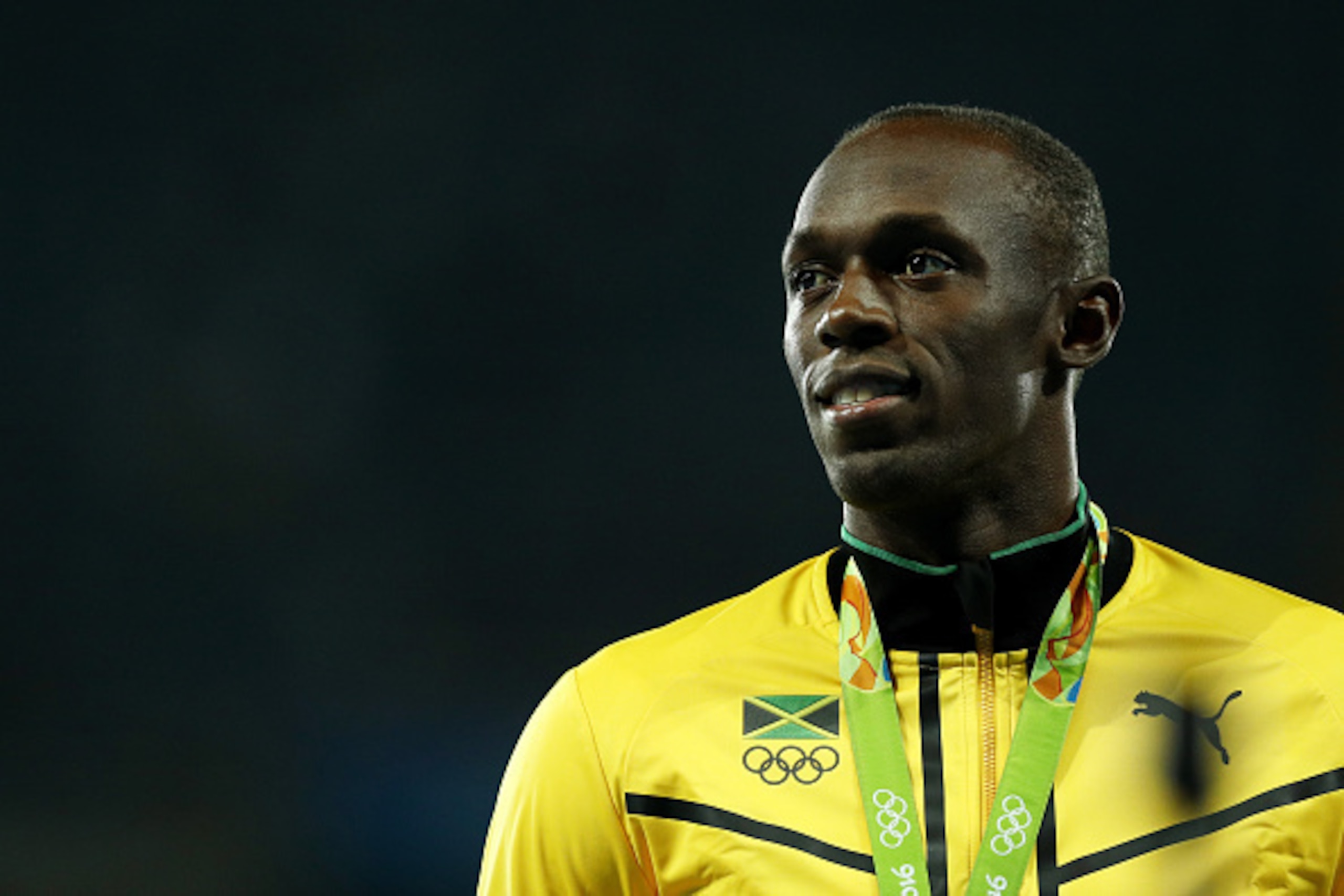 RIO DE JANEIRO, BRAZIL - AUGUST 15:  Gold medalist Usain Bolt of Jamaica poses on the podium during the medal ceremony for the MenÂs 100 metres on Day 10 of the Rio 2016 Olympic Games at the Olympic Stadium on August 15, 2016 in Rio de Janeiro, Brazil.  (