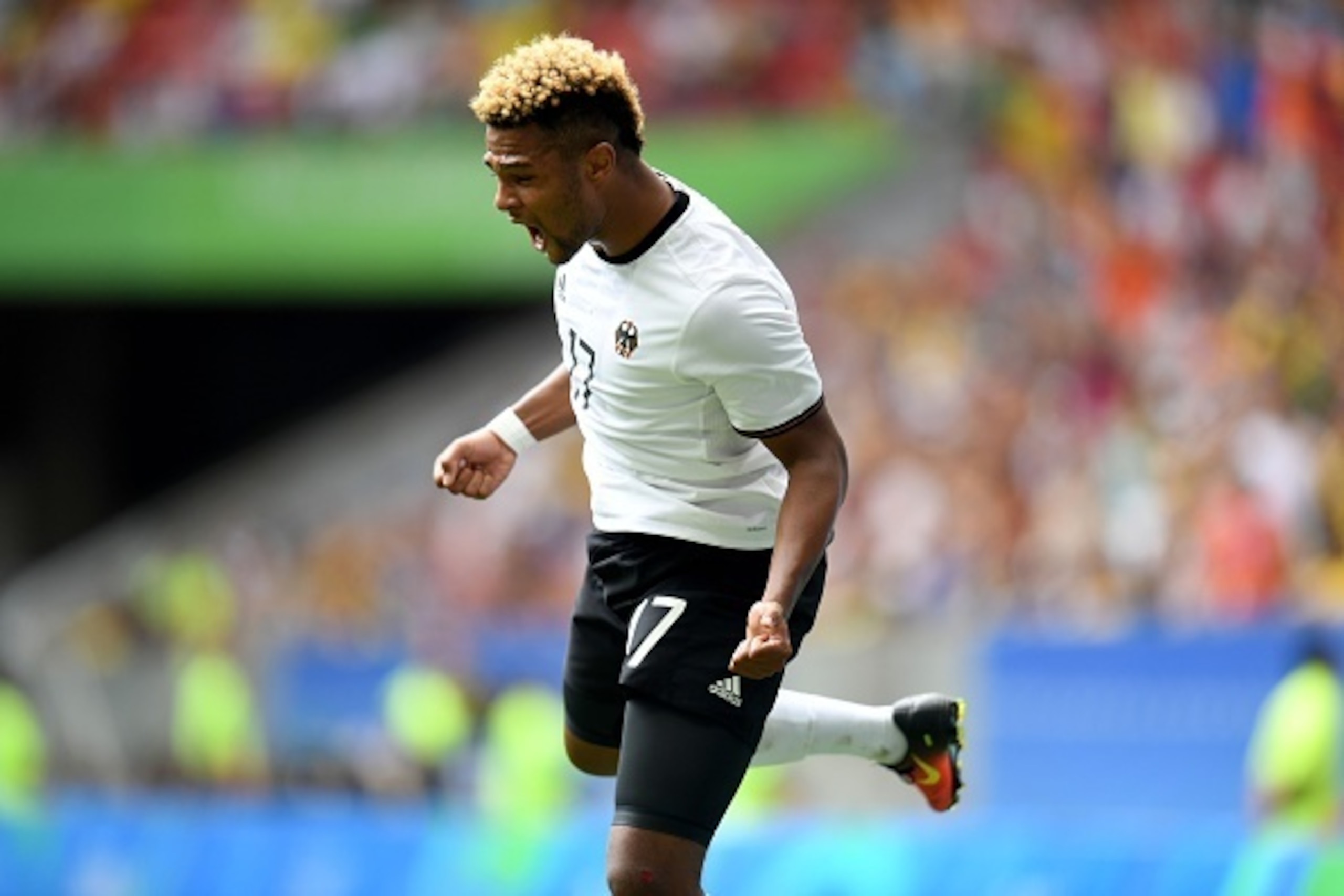 Germany 's players Serge Gnabry celebrates after he score during the Rio 2016 Olympic Games Quarter-finals men's football match Portugal vs Germany, at the Mane Garrincha Stadium in Brasilia on August 13, 2016. / AFP / EVARISTO SA        (Photo credit sho