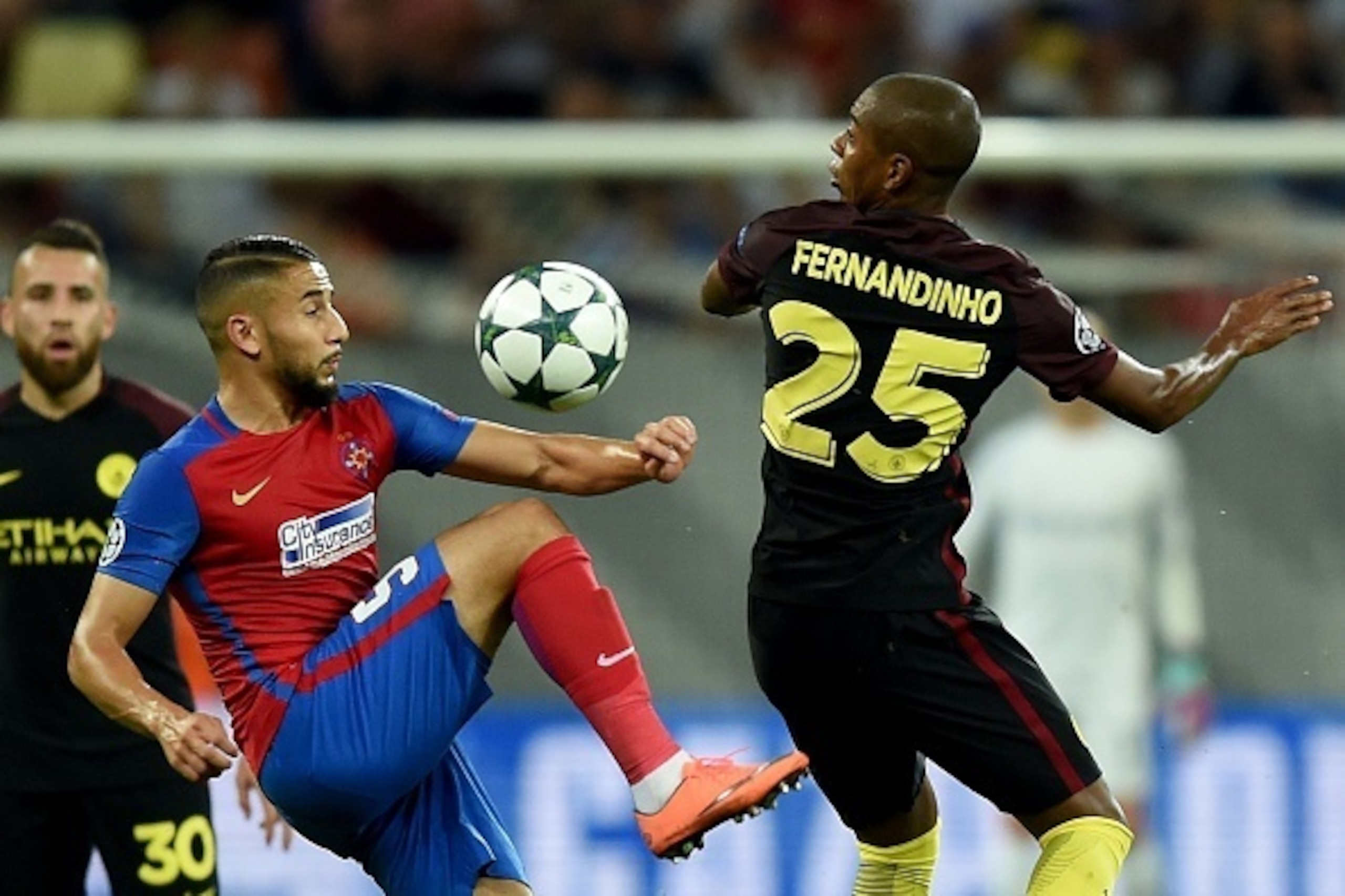 Manchester City's Brazilian midfielder Fernandinho (R) vies for the ball with Steaua Bucharest's Jugurtha Hamroun during the UEFA Champions league first leg play-off football match between Steaua Bucharest and Manchester City at the National Arena stadium Manchester City's Brazilian midfielder Fernandinho (R) vies for the ball with Steaua Bucharest's Jugurtha Hamroun during the UEFA Champions league first leg play-off football match between Steaua Bucharest and Manchester City at the National Arena stadium