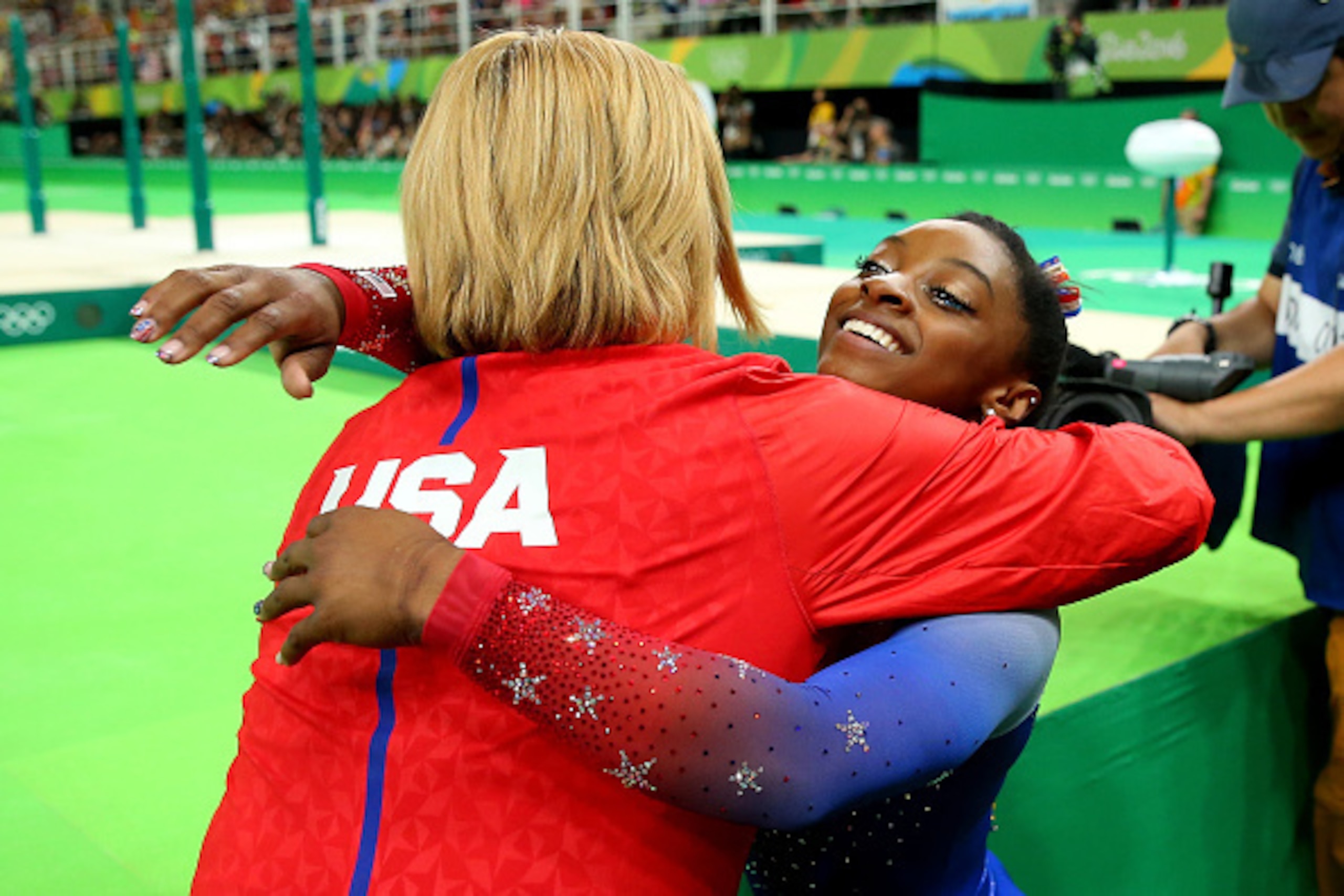 RIO DE JANEIRO, BRAZIL - AUGUST 16:  Simone Biles of the United States is embraced by her coach after competing on the Women's Floor on the Women's Floor final on Day 11 of the Rio 2016 Olympic Games at the Rio Olympic Arena on August 16, 2016 in Rio de J
