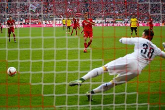 MUNICH, GERMANY - OCTOBER 04:  Thomas Mueller of Muenchen scores the second team goal with a penalty against Roman Buerki, keeper of Dortmund during the Bundesliga match between FC Bayern Muenchen and Borussia Dortmund at Allianz Arena on October 4, 2015 