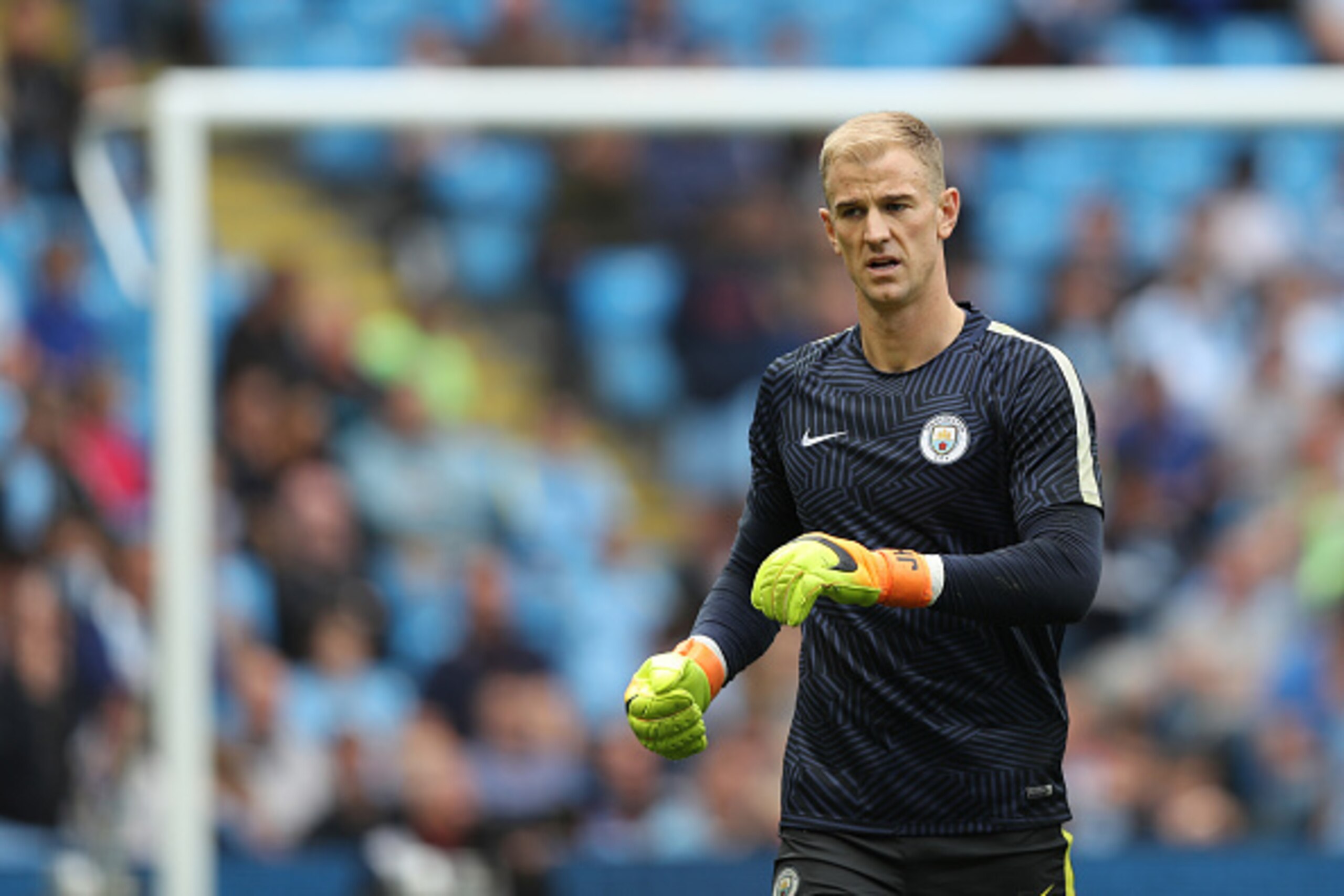 MANCHESTER, ENGLAND - AUGUST 13: A dejected Joe Hart of Manchester City walks off after warming up during the Premier League match between Manchester City and Sunderland at Etihad Stadium on August 13, 2016 in Manchester, England. (Photo by Matthew Ashton