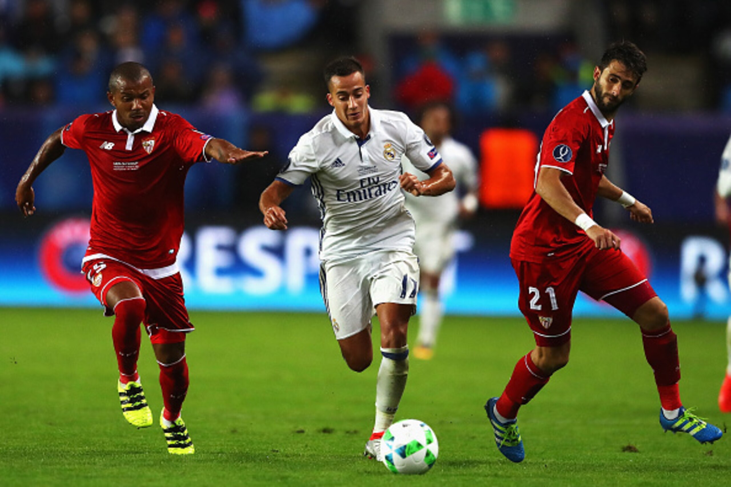 TRONDHEIM, NORWAY - AUGUST 09: Lucas Vazquez of Real Madrid is closed down by Mariano Ferreira (L) and Nicolas Pareja of Sevilla during the UEFA Super Cup match between Real Madrid and Sevilla at Lerkendal Stadion on August 9, 2016 in Trondheim, Norway.  