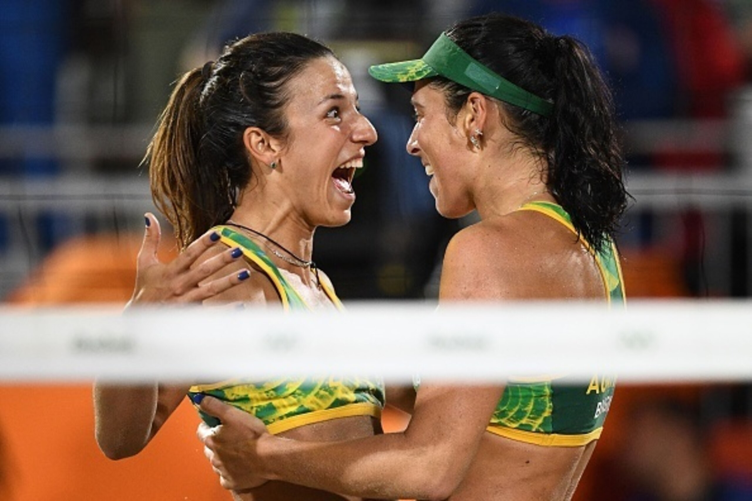 Brazil's Agatha Bednarczuk (R) and Brazil's Barbara Seixas De Freitas celebrate after winning  the women's beach volleyball semi-final match between USA and Brazil at the Beach Volley Arena in Rio de Janeiro on August 16, 2016, as part of the Rio 2016 Oly