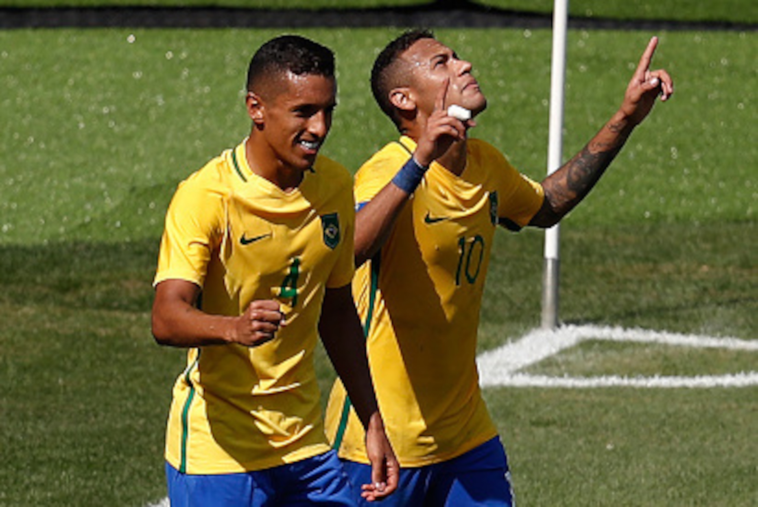 Brazil's Marquinhos (L) and Neymar celebrate after teammate Gabriel Jesus scored the team's third goal against Honduras during their Rio 2016 Olympic Games men's football semifinal match at the Maracana stadium in Rio de Janeiro, Brazil, on August 17, 201