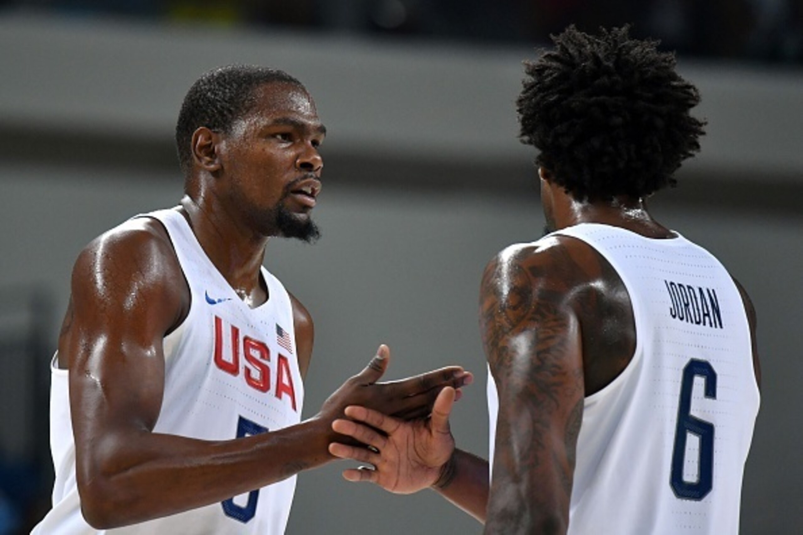 USA's guard Kevin Durant (L) celebrates a point with USA's centre DeAndre Jordan during a Men's quarterfinal basketball match between USA and Argentina at the Carioca Arena 1 in Rio de Janeiro on August 17, 2016 during the Rio 2016 Olympic Games. / AFP / 