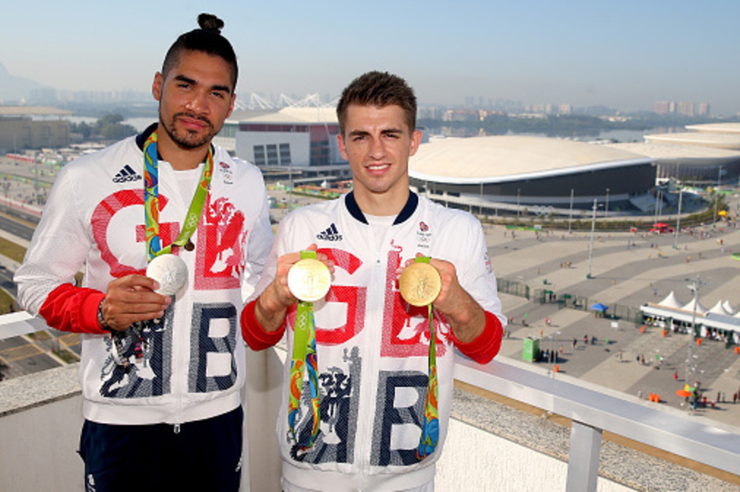 RIO DE JANEIRO, BRAZIL - AUGUST 15:  Max Whitlock (R) and Louis Smith of Great Britain pose for photographs with their medals in front of the Olympic Park on day 10 of the Rio 2016 Olympic Games at Rio Olympic Arena on August 15, 2016 in Rio de Janeiro, B