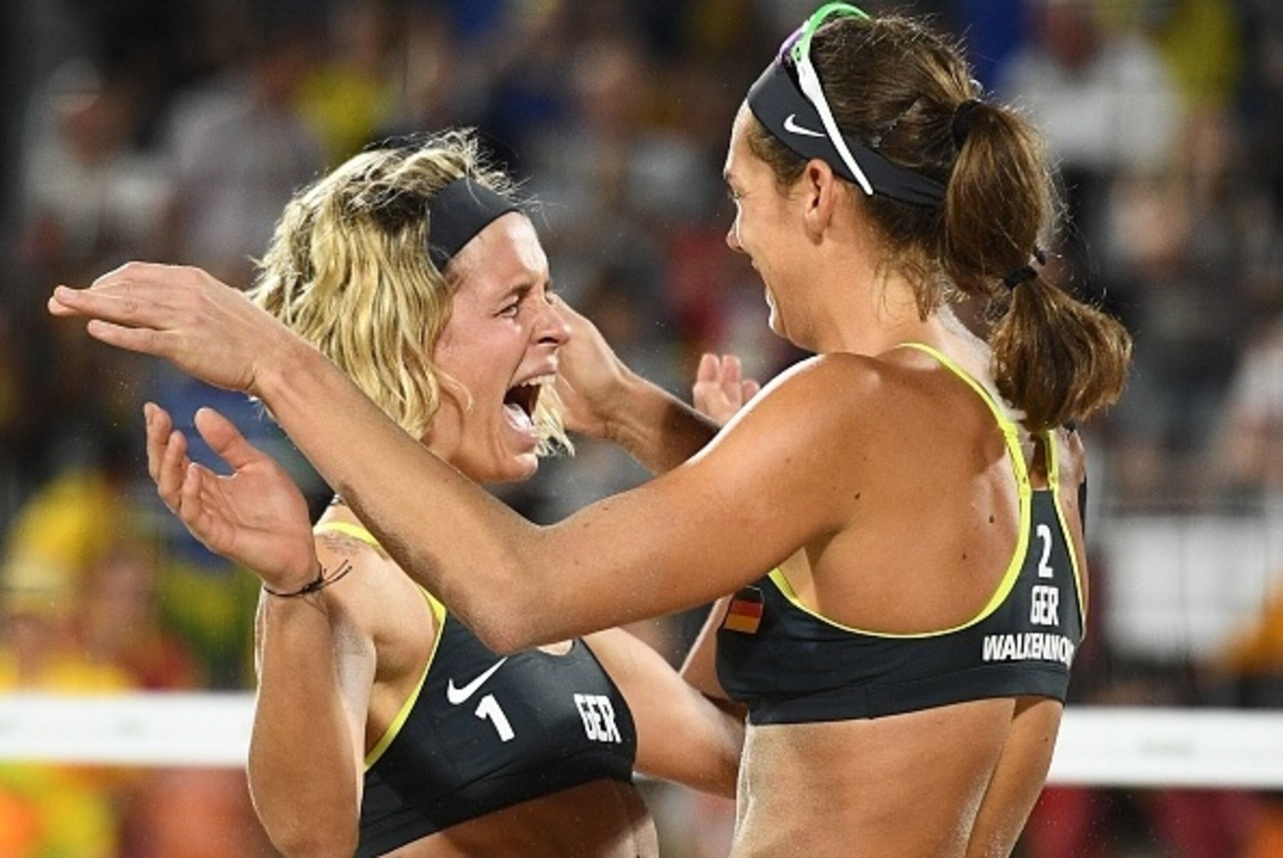 Germany's Laura Ludwig (L) and Germany's Kira Walkenhorst celebrate after winning the women's beach volleyball final match between Brazil and Germany at the Beach Volley Arena in Rio de Janeiro late on August 17, 2016, for the Rio 2016 Olympic Games. / AF Germany's Laura Ludwig (L) and Germany's Kira Walkenhorst celebrate after winning the women's beach volleyball final match between Brazil and Germany at the Beach Volley Arena in Rio de Janeiro late on August 17, 2016, for the Rio 2016 Olympic Games. / AF