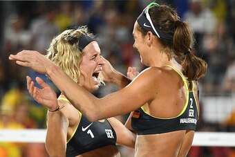 Germany's Laura Ludwig (L) and Germany's Kira Walkenhorst celebrate after winning the women's beach volleyball final match between Brazil and Germany at the Beach Volley Arena in Rio de Janeiro late on August 17, 2016, for the Rio 2016 Olympic Games. / AF