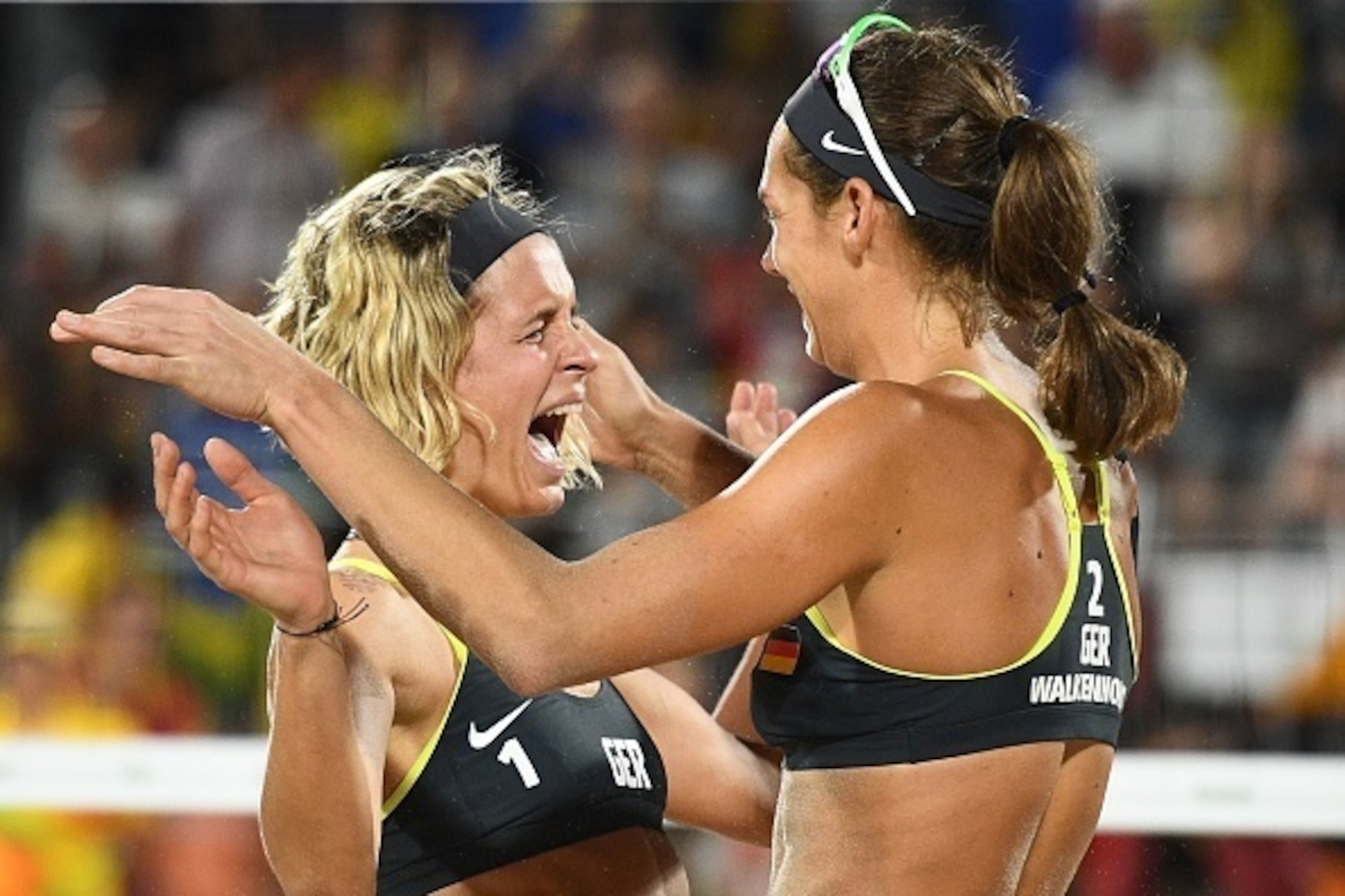 Germany's Laura Ludwig (L) and Germany's Kira Walkenhorst celebrate after winning the women's beach volleyball final match between Brazil and Germany at the Beach Volley Arena in Rio de Janeiro late on August 17, 2016, for the Rio 2016 Olympic Games. / AF