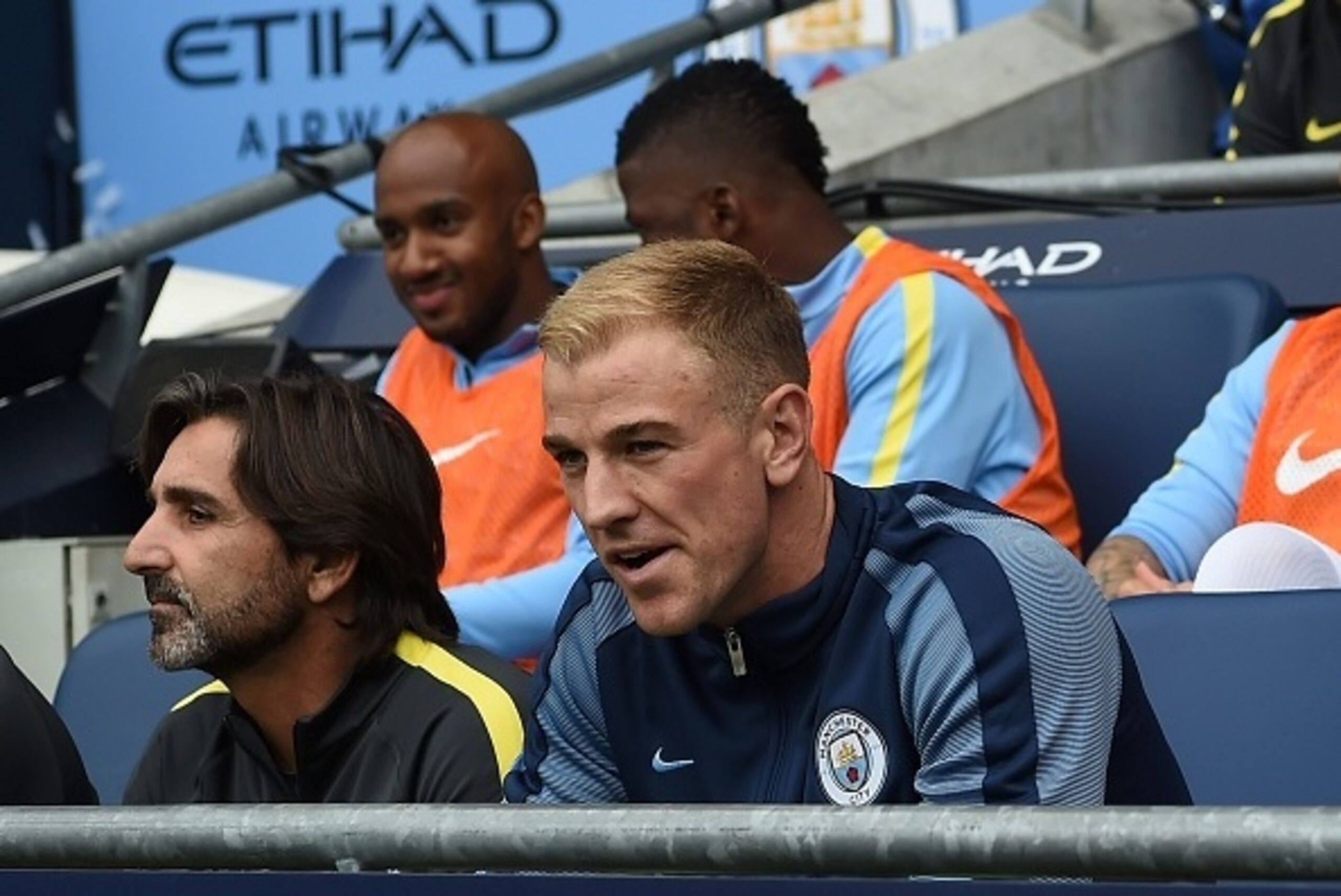 Manchester City's English goalkeeper Joe Hart (R) sits on the substitutes bench for the English Premier League football match between Manchester City and Sunderland at the Etihad Stadium in Manchester, north west England, on August 13, 2016.
Manchester Ci