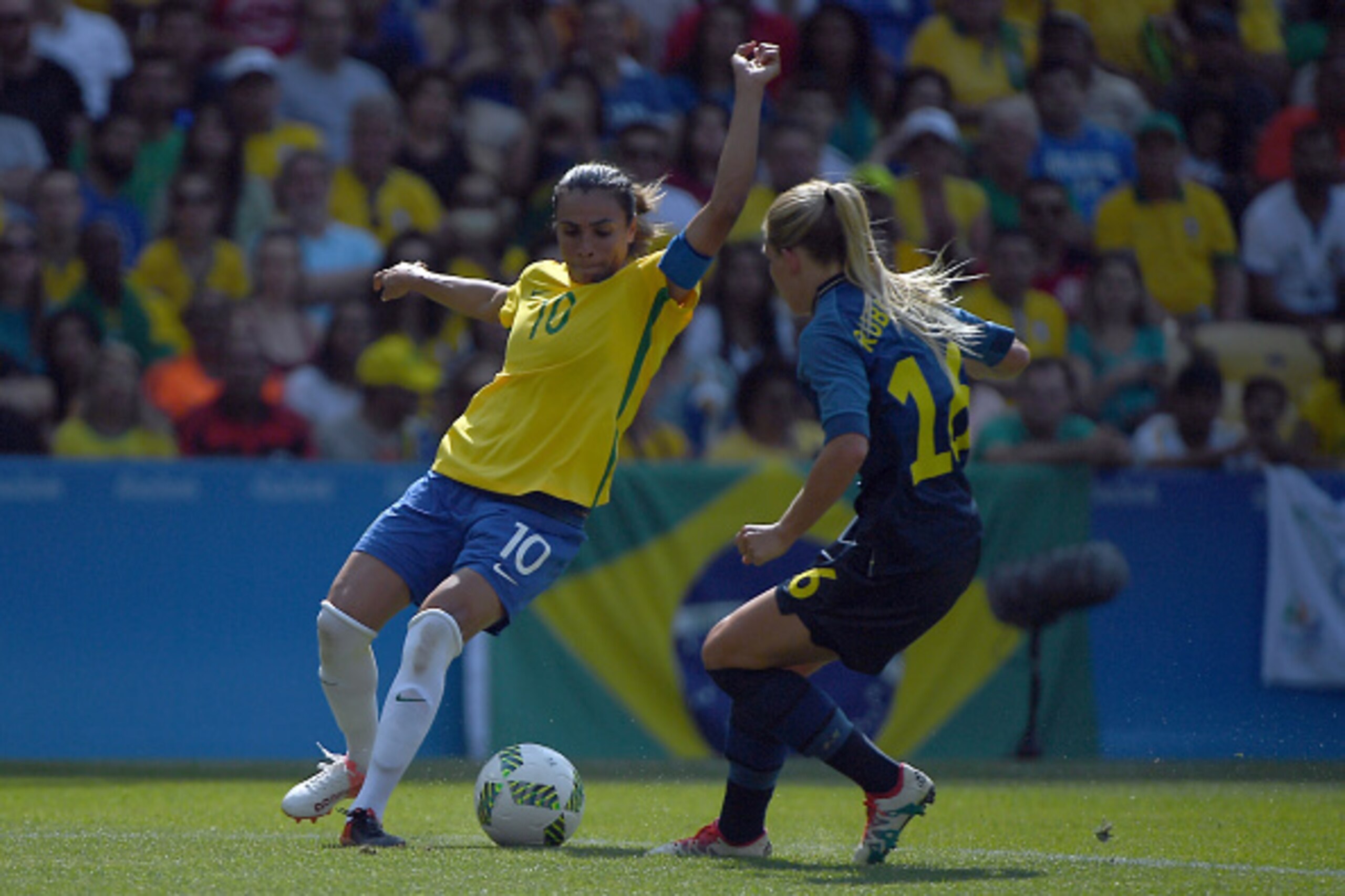 RIO DE JANEIRO, BRAZIL - AUGUST 16: Marta of Brazil battles Hilda Carlen of Sweden during the Women's Football Semi Final between Brazil and Sweden on Day 11 of the Rio 2016 Olympic Games at Maracana Stadium on August 16, 2016 in Rio de Janeiro, Brazil. RIO DE JANEIRO, BRAZIL - AUGUST 16: Marta of Brazil battles Hilda Carlen of Sweden during the Women's Football Semi Final between Brazil and Sweden on Day 11 of the Rio 2016 Olympic Games at Maracana Stadium on August 16, 2016 in Rio de Janeiro, Brazil.