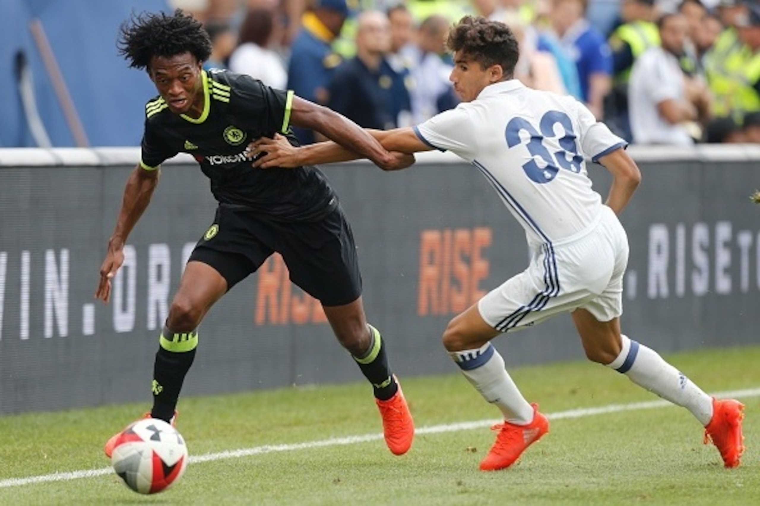 Chelsea forward Juan Cuadrado (L) kicks the ball past Real Madrid defender Achraf Hakimi (R) during an International Champions Cup soccer match in Ann Arbor, Michigan on July 30, 2016. / AFP / Jay LaPrete        (Photo credit should read JAY LAPRETE/AFP/G