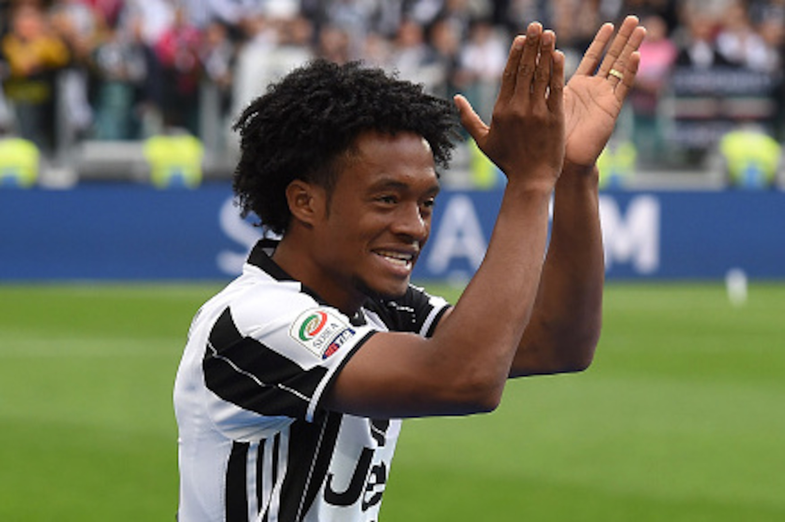 TURIN, ITALY - MAY 14:  Juan Cuadrado of Juventus FC celebrates after beating UC Sampdoria 5-0 to win the Serie A Championships after the Serie A match between Juventus FC and UC Sampdoria at Juventus Arena on May 14, 2016 in Turin, Italy.  (Photo by Vale