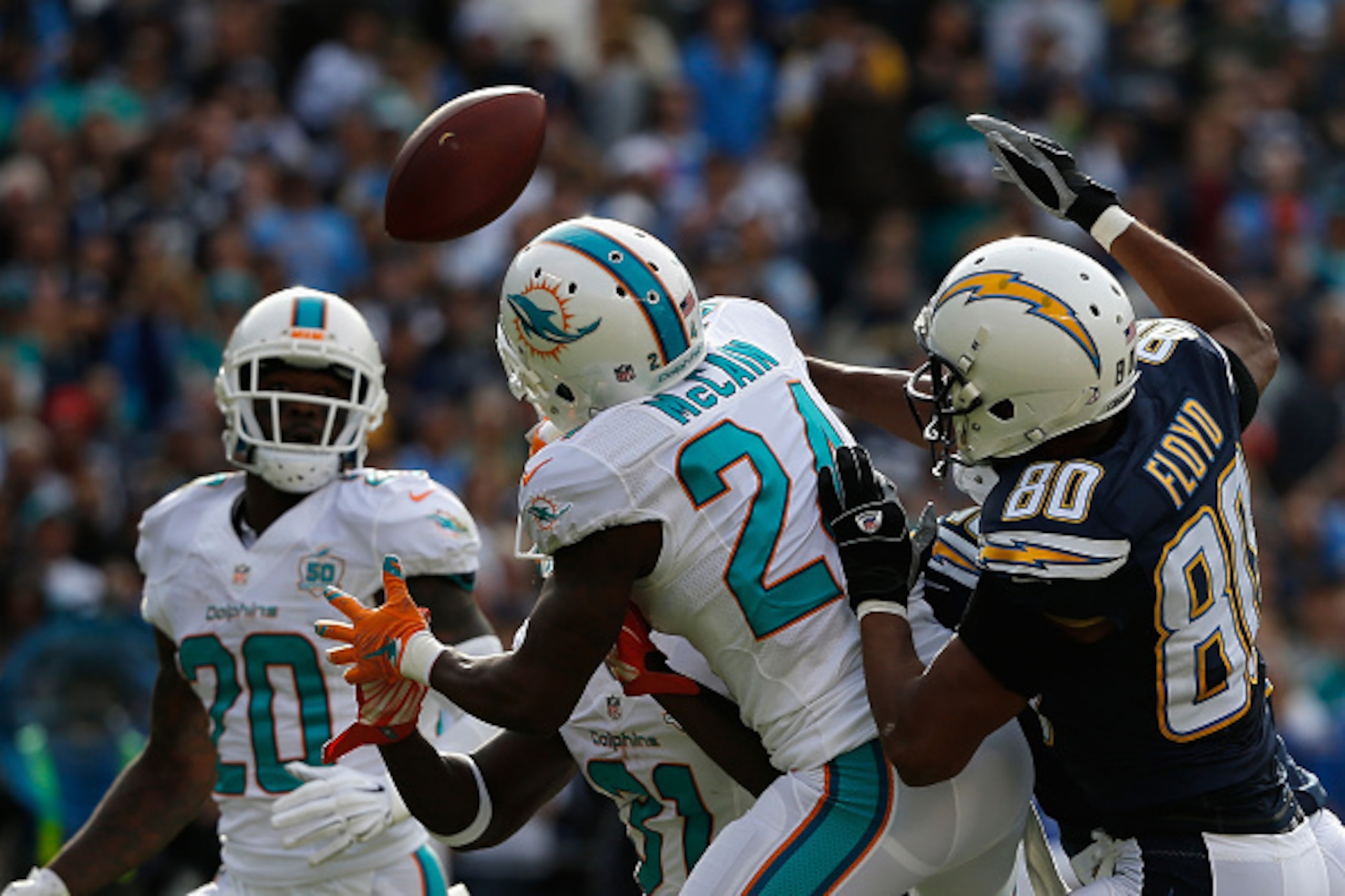 SAN DIEGO, CA - DECEMBER 20:  Brice McCain #24 of the Miami Dolphins breaks up a San Diego Chargers pass attempt that is intercepted by  Reshad Jones #20 of the Miami Dolphins at Qualcomm Stadium on December 20, 2015 in San Diego, California.  (Photo by S