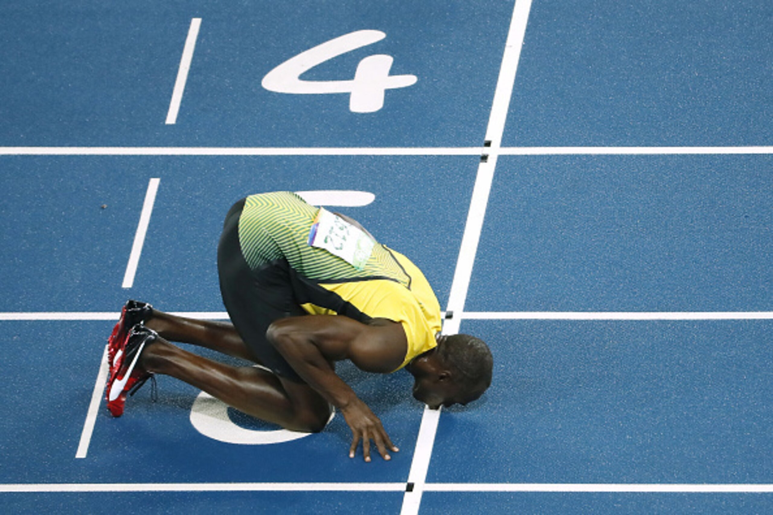 Jamaica's Usain Bolt kisses the track as he celebrates after winning the Men's 200m Final during the athletics event at the Rio 2016 Olympic Games at the Olympic Stadium in Rio de Janeiro on August 18, 2016.   / AFP / Odd ANDERSEN        (Photo credit sho