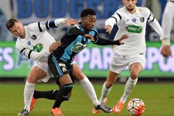 Granville's defender Mathias Jouan (L) vies for the ball with Marseille's French midfielder Georges-Kevin Nkoudou (C) during the French Cup quarter final football match between Granville (US) and Marseille (OM), on March 3, 2016, at the Michel d'Ornano st