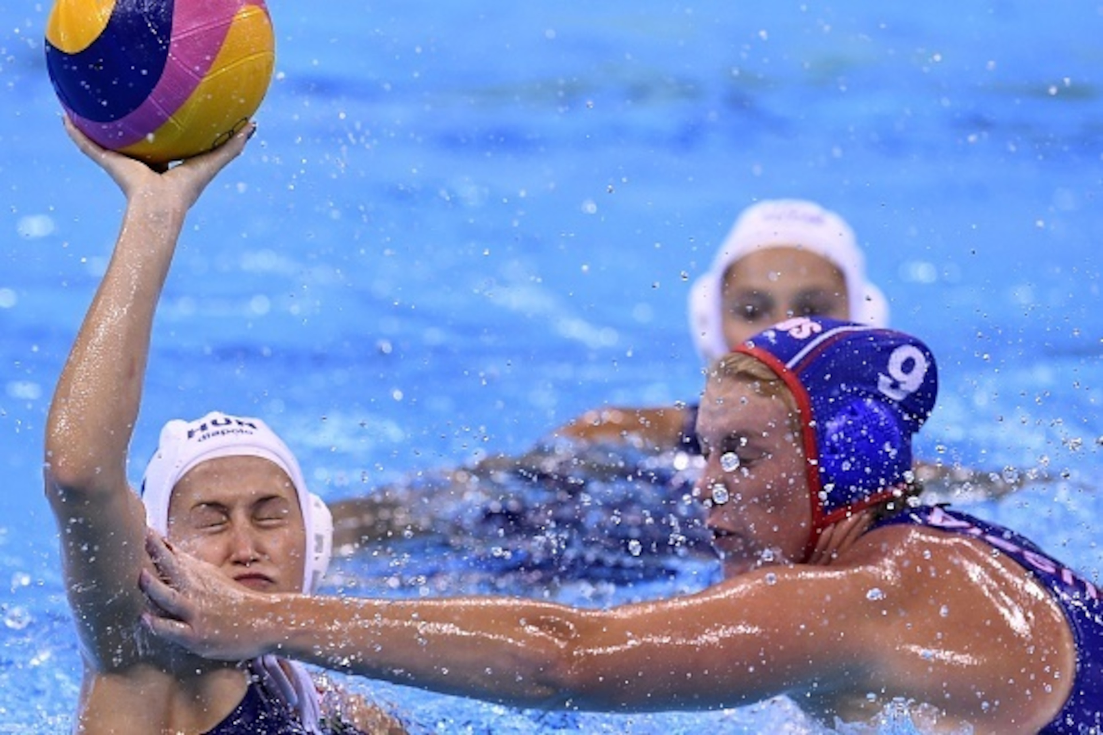 Hungary's Dora Czigany (L) vies with Russia's Anna Timofeeva during their Rio 2016 Olympic Games waterpolo Bronze medal match on August 19, 2016 at the Olympic Aquatics Stadium in Rio de Janeiro.   / AFP / GABRIEL BOUYS        (Photo credit should read GA