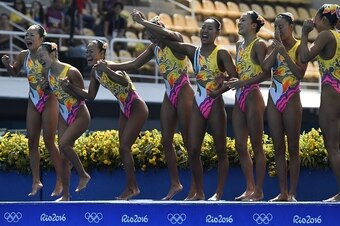 Team Japan waves after competing in the Teams Free Routine final during the synchronised swimming event at the Maria Lenk Aquatics at the Rio 2016 Olympic Games in Rio de Janeiro on August 19, 2016.  / AFP / CHRISTOPHE SIMON        (Photo credit should re